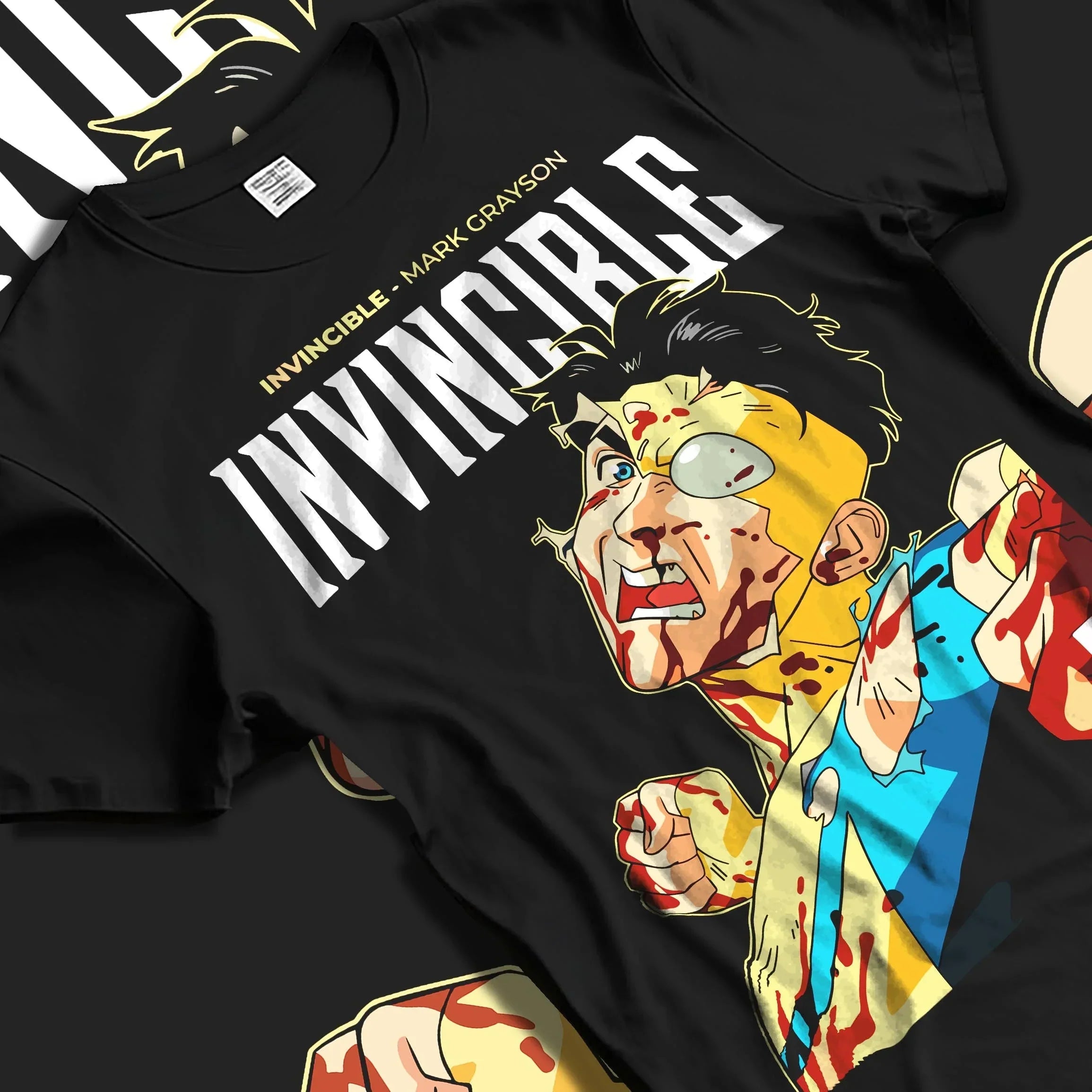Black T-shirt laid flat featuring Invincible anime-style graphic of Mark Grayson battle-worn with bold comic typography.