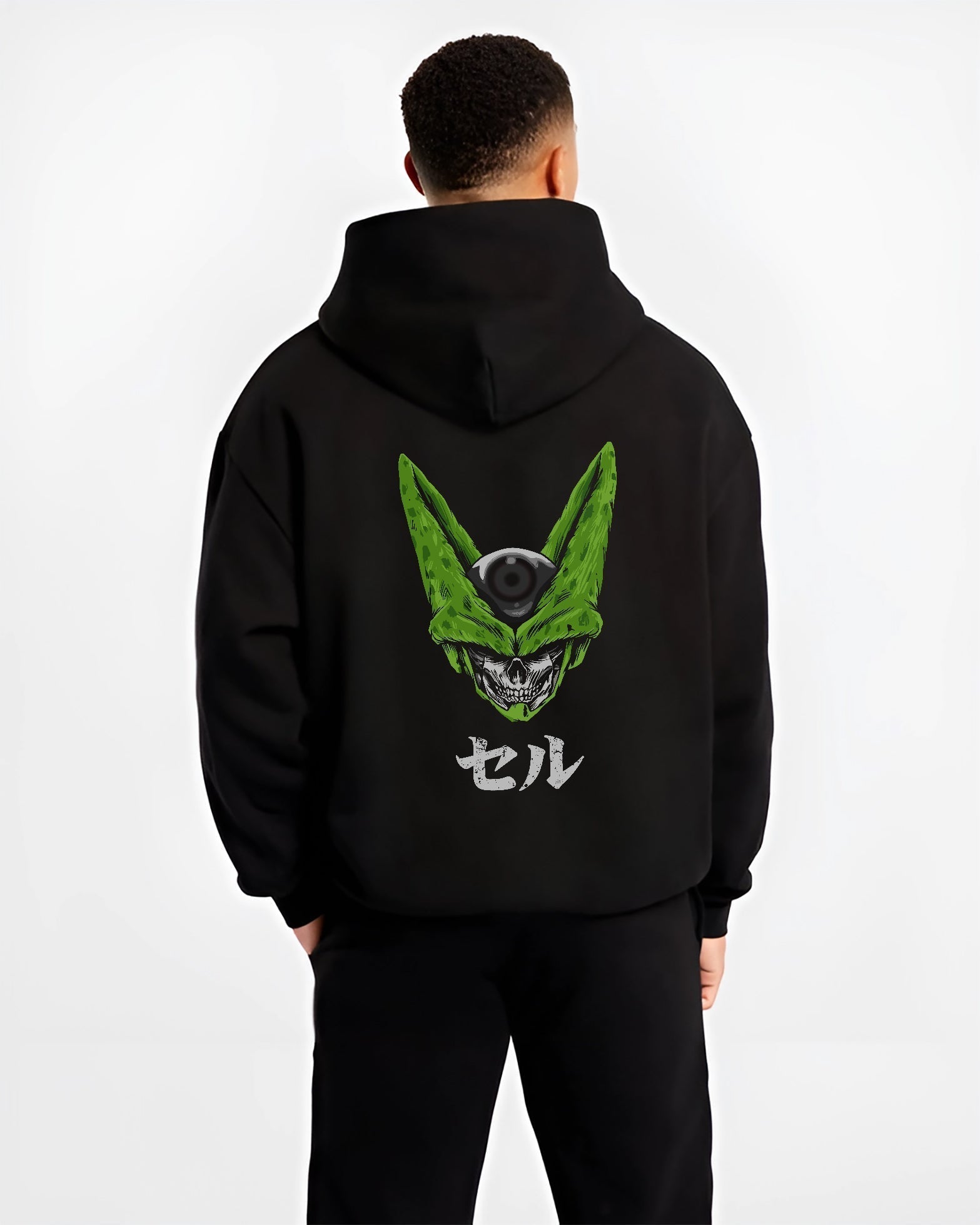 Black hoodie worn by a male model, back view, featuring Dragon Ball Cell skull fusion dark manga panel artwork in retro streetwear style.
