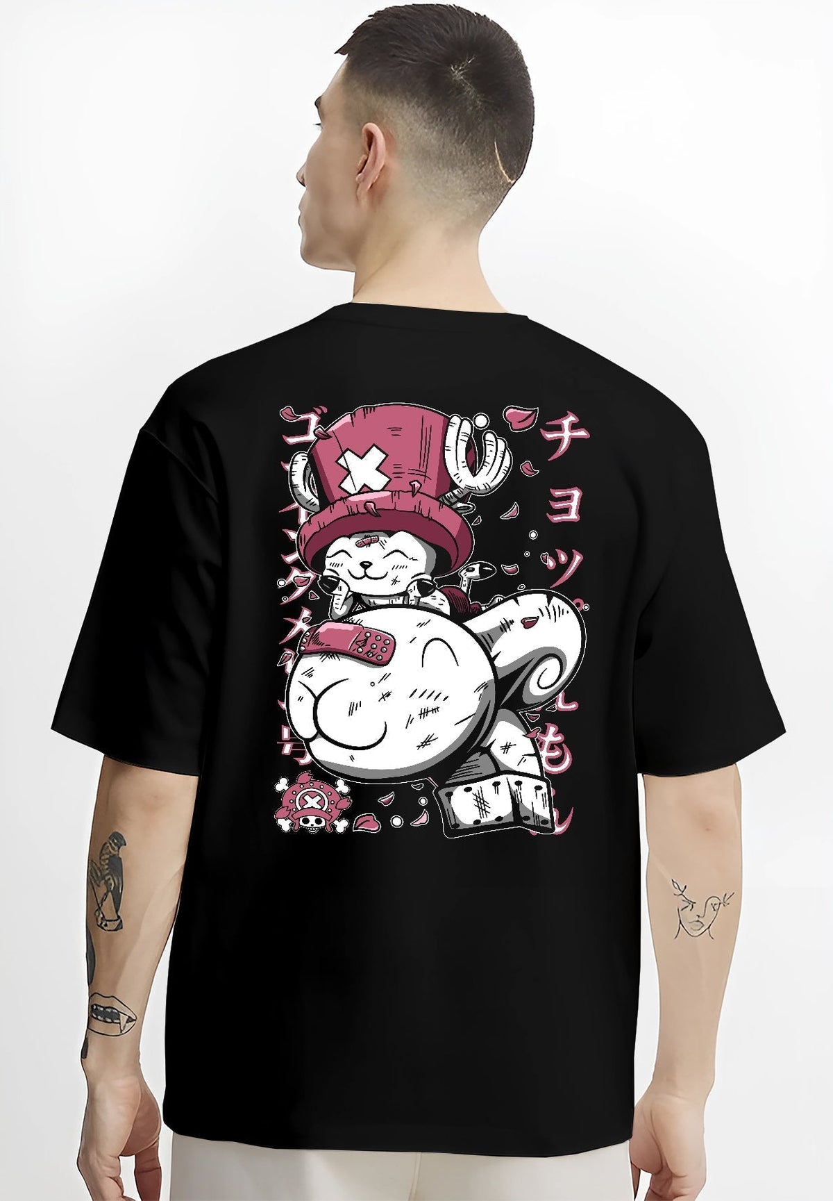 Black T-shirt worn by a male model, back view, featuring One Piece Tony Tony Chopper retro comic style artwork with pink tones and Japanese streetwear flair.