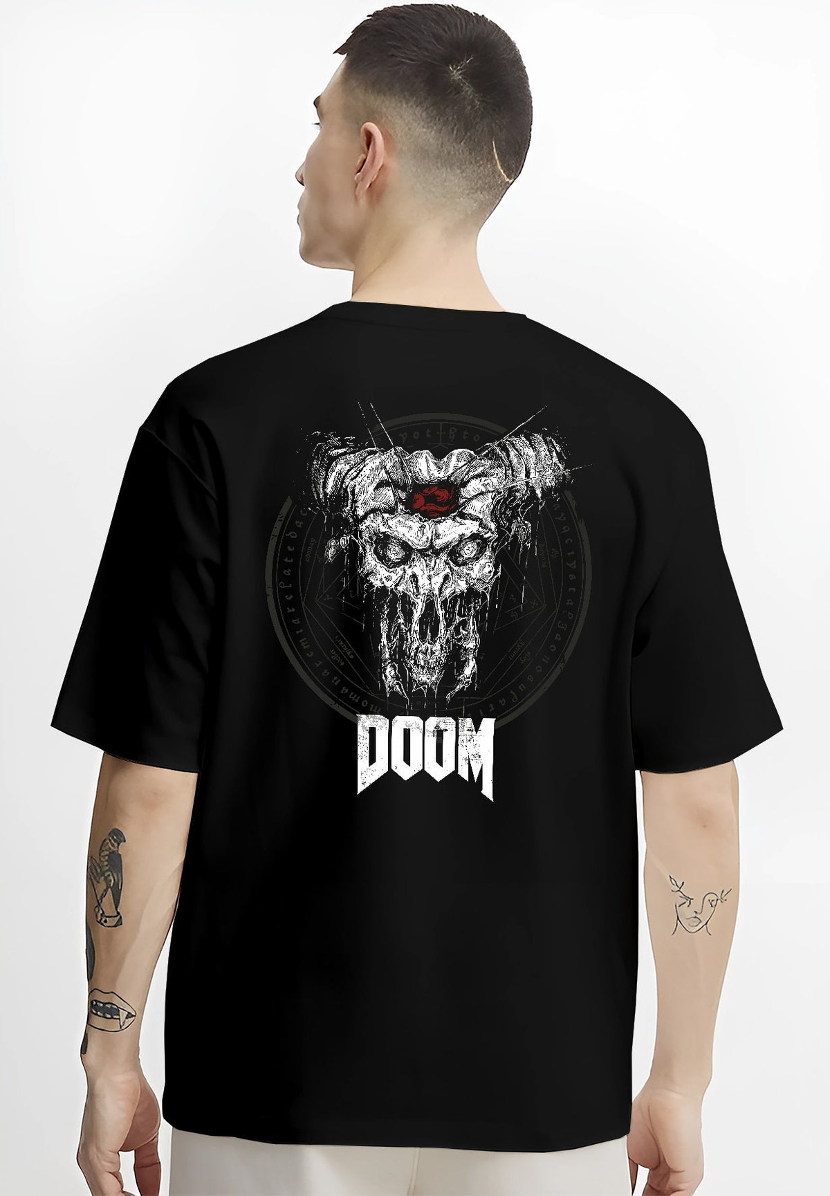 Black T-shirt worn by a male model, back view, featuring DOOM skull with horns artwork in gothic horror poster aesthetic and retro gaming inspired style.