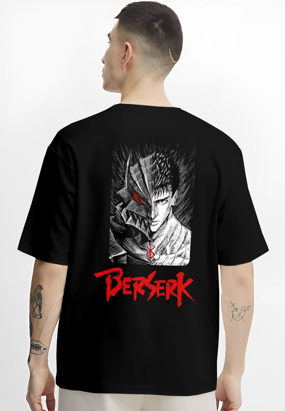Black T-shirt worn by a male model, back view, featuring Berserk Guts anime poster inspired artwork with split face in dark manga panel and retro horror vibe.