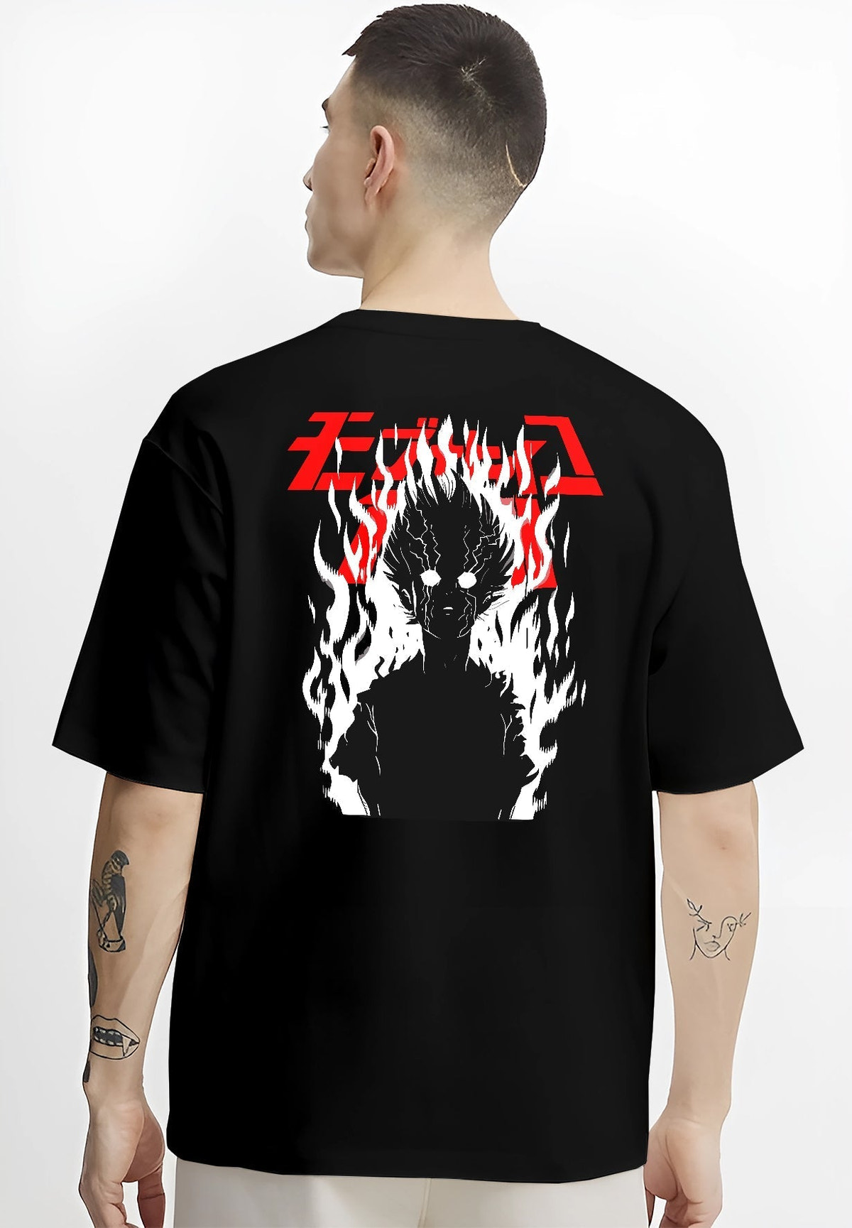 Black T-shirt worn by a male model, back view, featuring Mob Psycho 100 dark silhouette manga poster design with fiery aura and bold lettering.
