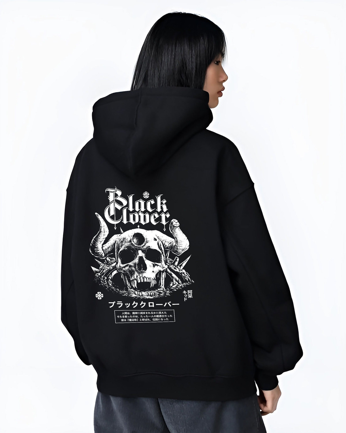 Black hoodie worn by a female model, back view, featuring Black Clover skull and horns manga panel design with retro Japanese streetwear graphic tones.