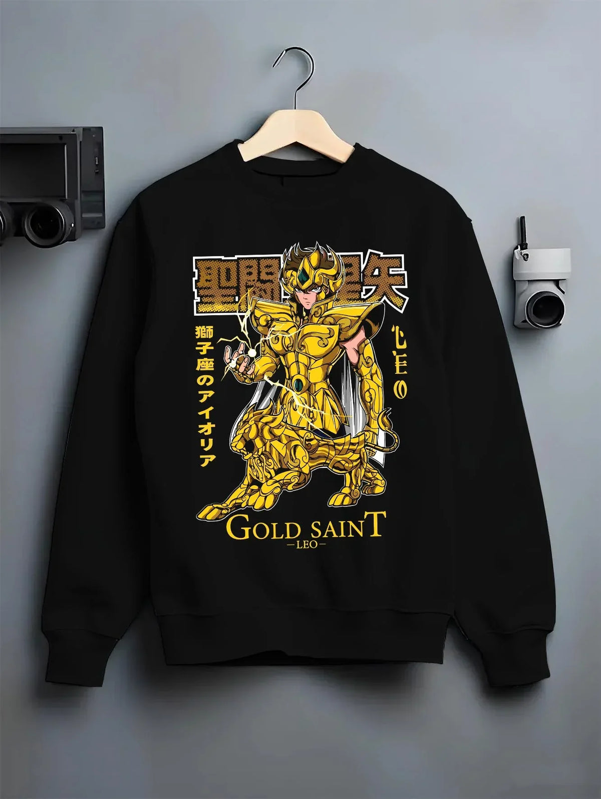 Black crewneck sweatshirt on hanger with Aiolia Gold Saint Hoodie Saint Seiya Mythic Armour graphic premium wear.