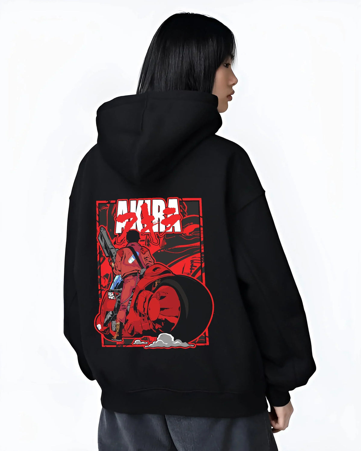 Black hoodie worn by female model, back view with Akira Neo Tokyo Hoodie Kaneda Bike Retro Future Scene graphic Akira anime graphic.