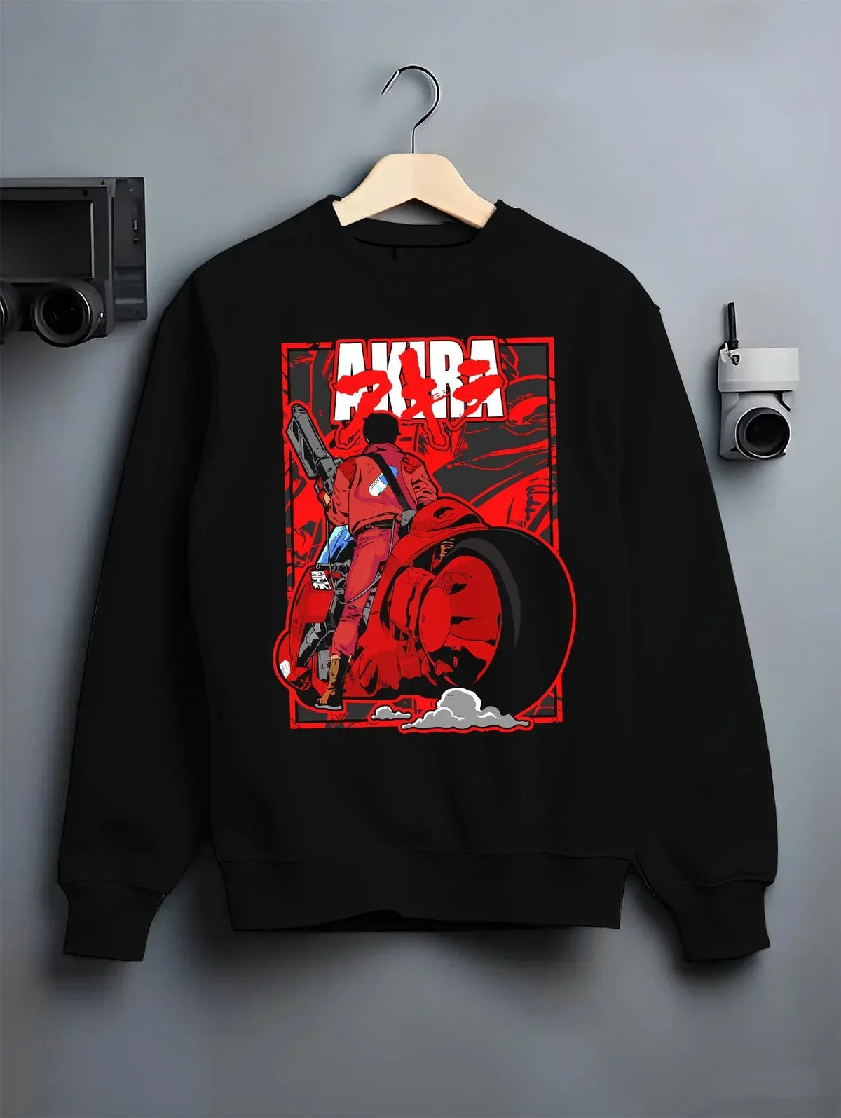 Black crewneck sweatshirt on hanger with Akira Neo Tokyo Hoodie Kaneda Bike Retro Future Scene graphic bold anime graphic.