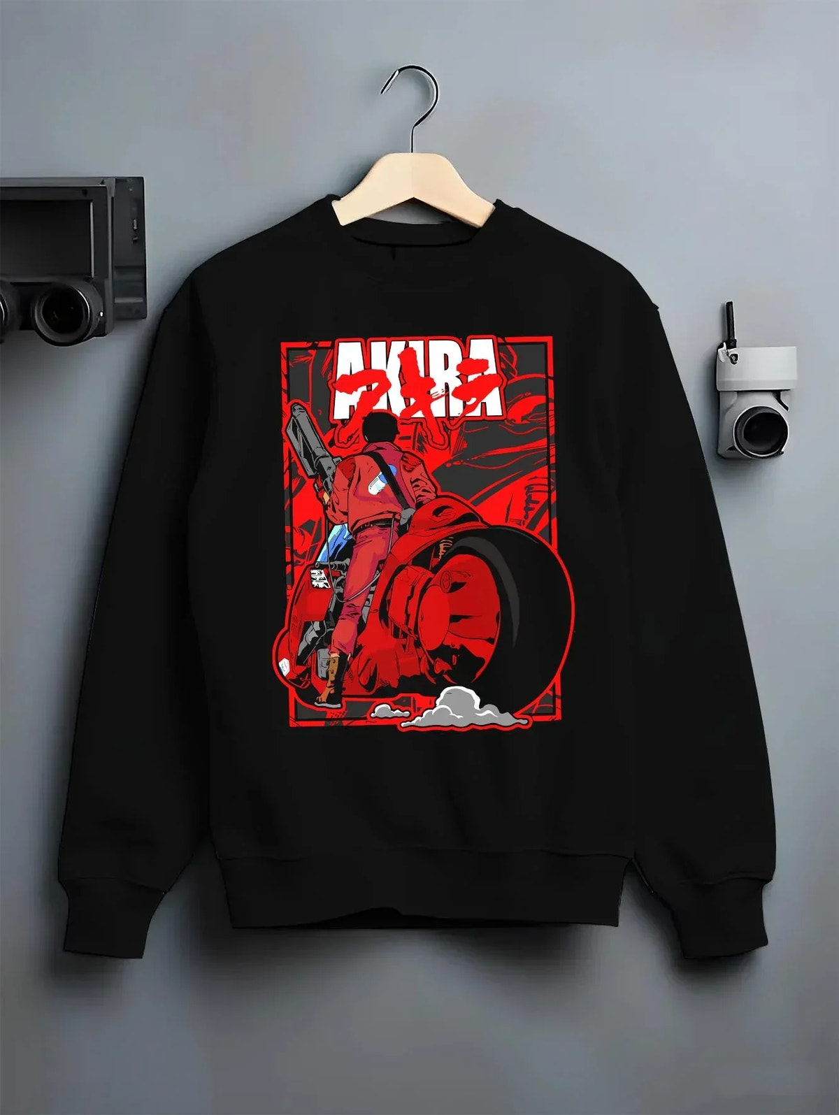 Black crewneck sweatshirt on hanger with Akira Neo Tokyo Hoodie Kaneda Bike Retro Future Scene graphic bold anime graphic.