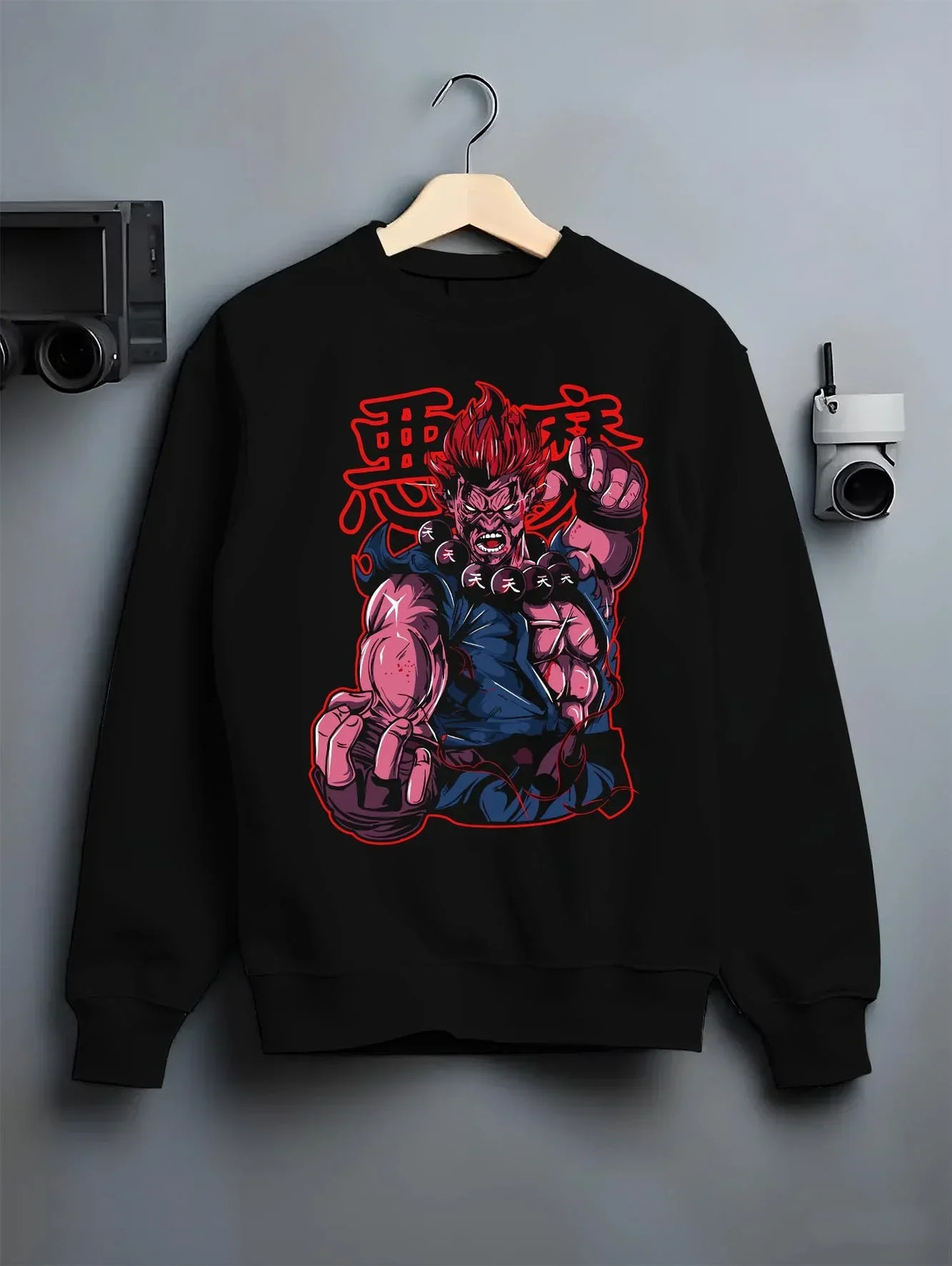 Black crewneck sweatshirt on hanger with Akuma Raging Demon Hoodie Street Fighter Dark Energy graphic streetwear graphic.