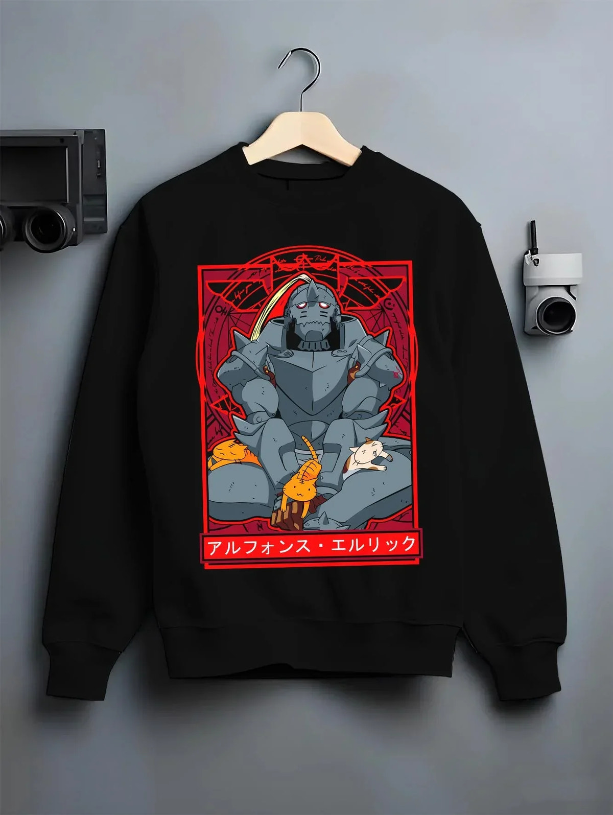 Black crewneck sweatshirt on hanger with Alphonse Elric Hoodie Fullmetal Alchemist Cat Edition graphic premium wear.