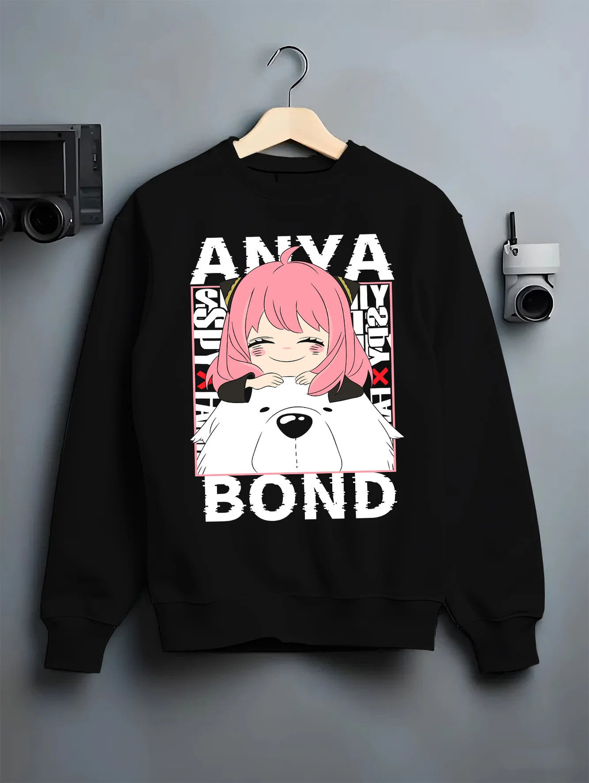 Black crewneck sweatshirt on hanger with Anya Forger and Bond from Spy x Family illustrated back graphic