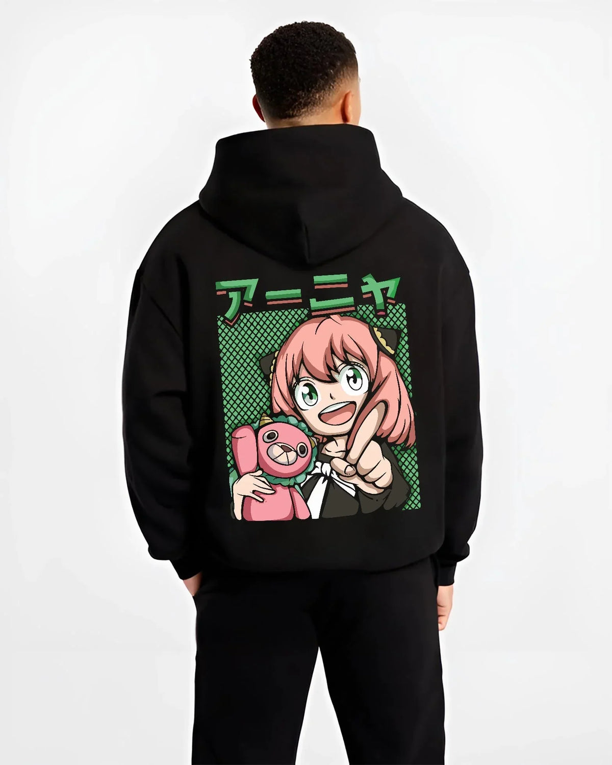Black hoodie worn by male model, back view with Anya Forger Hoodie Spy x Family Retro Pop Art Smile graphic streetwear graphic.