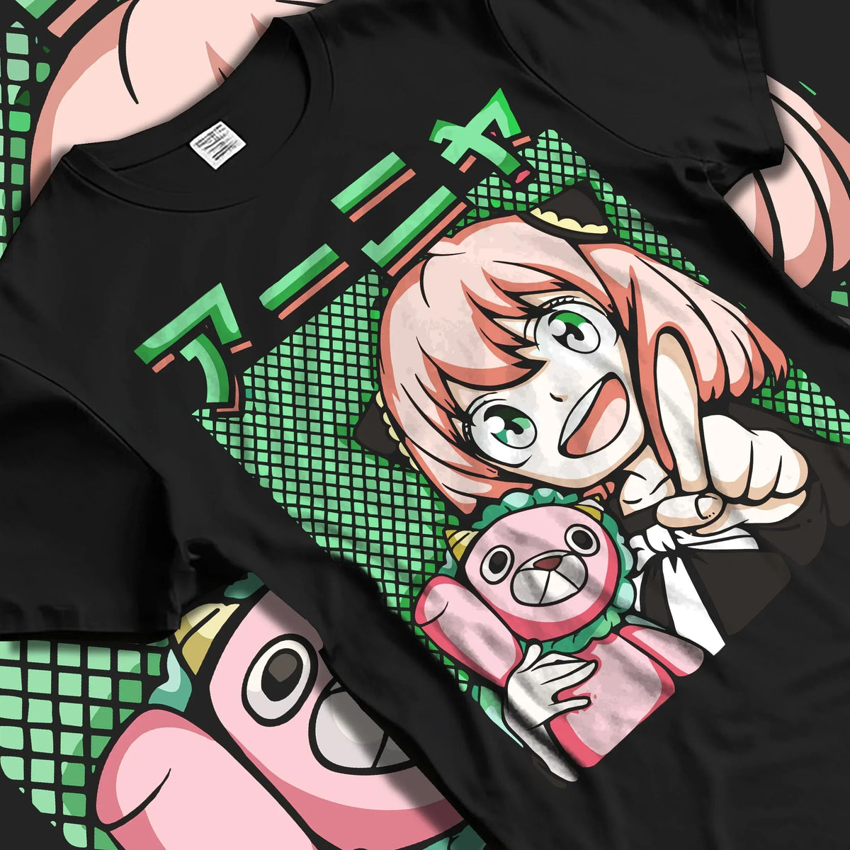 Black T-shirt laid flat with natural folds with Anya Forger Hoodie Spy x Family Retro Pop Art Smile graphic premium wear.
