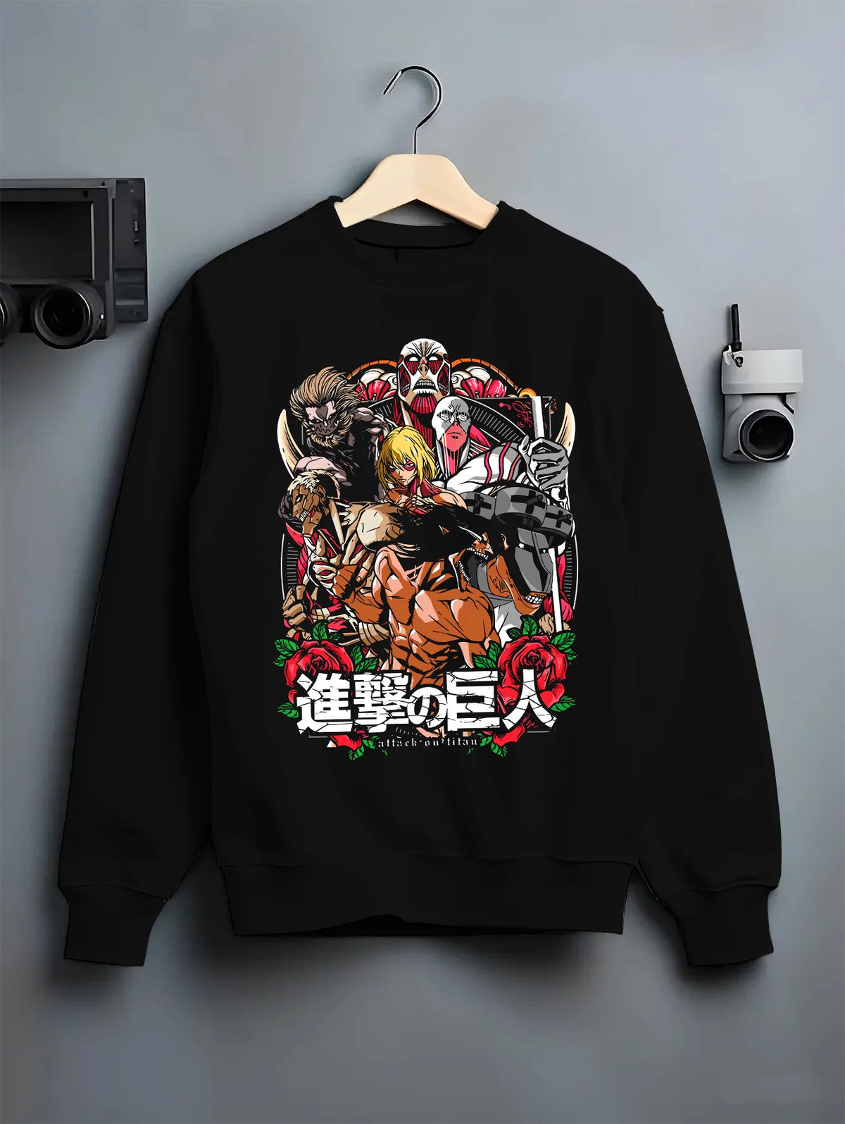 Black crewneck sweatshirt on hanger showing Attack on Titan: character and Titan group artwork