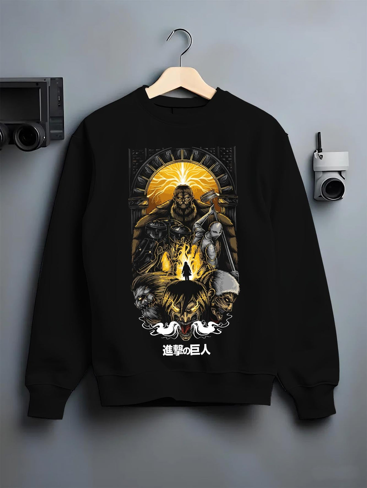 Black crewneck sweatshirt on a hanger against a grey wall, featuring Attack on Titan anime poster inspired design with retro manga artwork print and dystopian anime aesthetic.