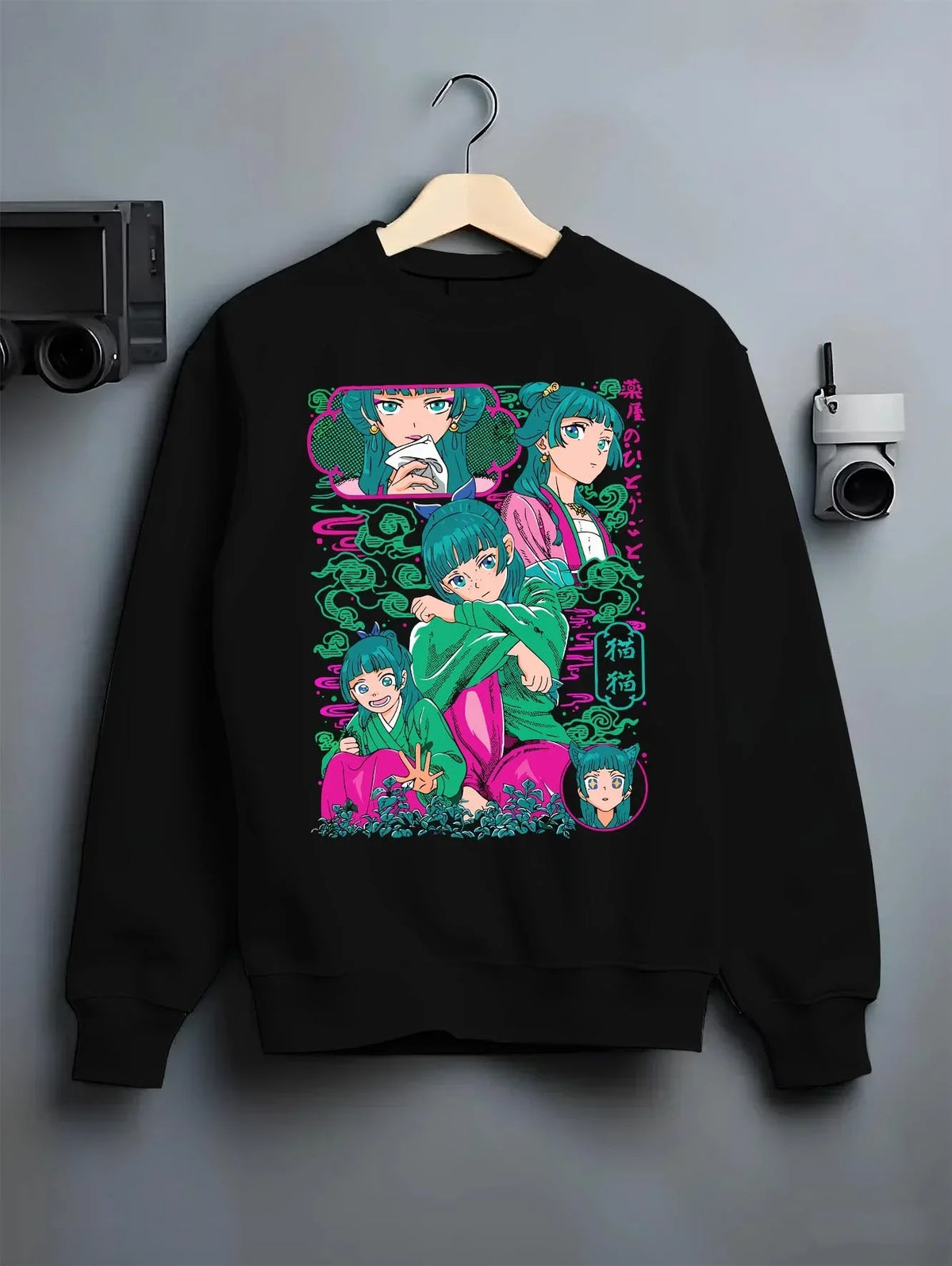 Black crewneck sweatshirt on hanger with Apothecary Diaries Hoodie Maomao Pink Hair Trio Panel graphic bold anime graphic.