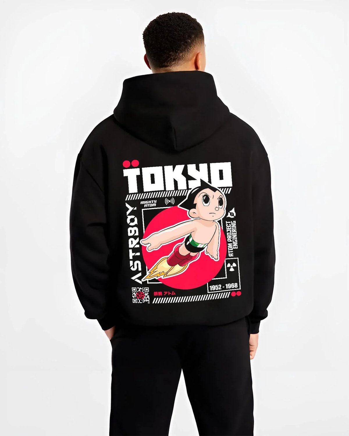 Black hoodie worn by male model, back view with Astro Boy Hoodie Retro Tokyo Anime Robot Hero Poster graphic bold anime graphic.