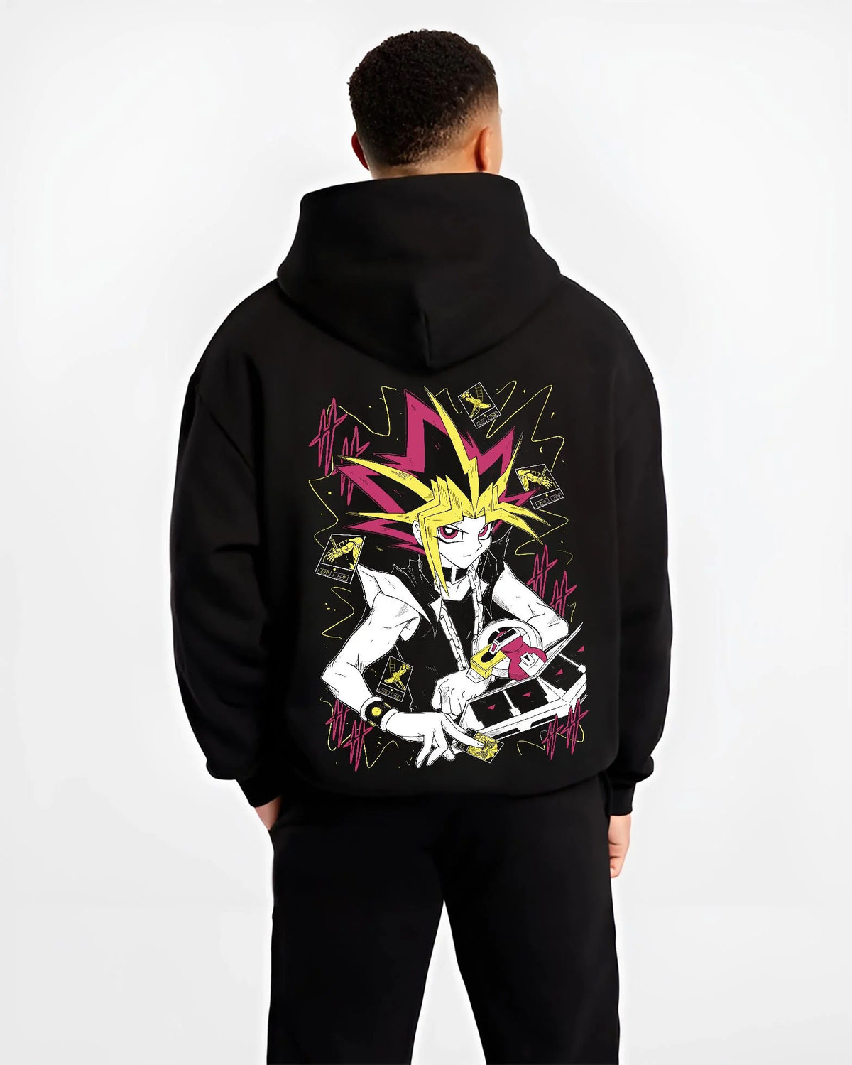Black hoodie worn by male model from the back featuring Atem and Dark Magician Yu-Gi-Oh duel spirit artwork.