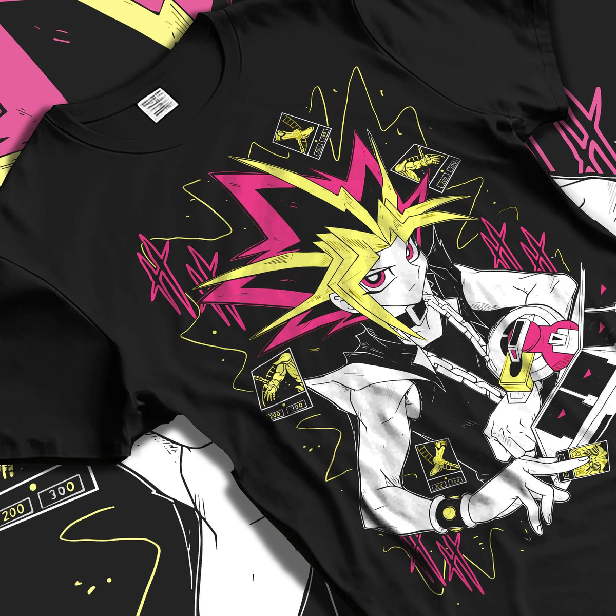 Black T-shirt laid flat with natural folds featuring Atem and Dark Magician Yu-Gi-Oh duel spirit artwork.
