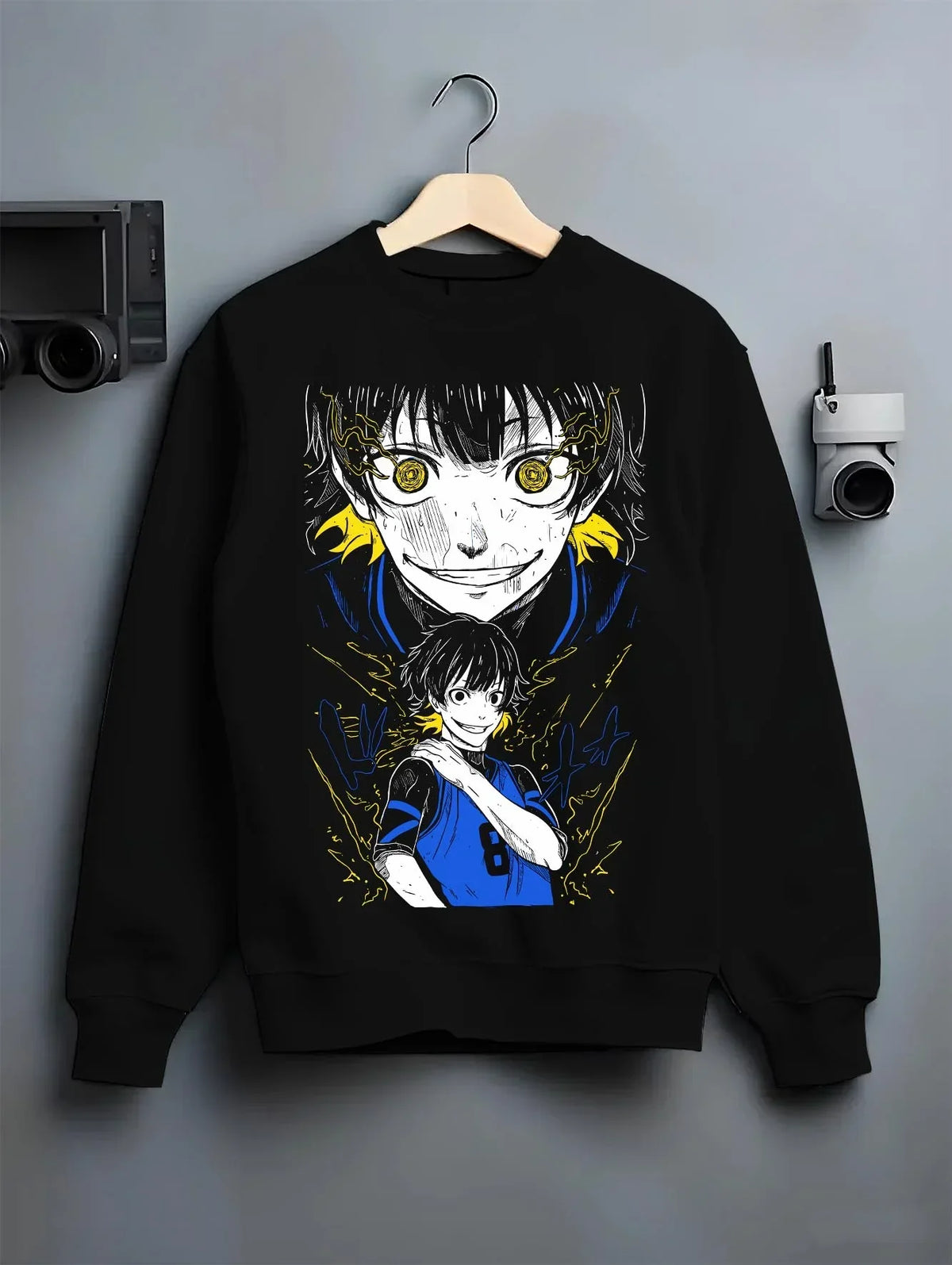 Black crewneck sweatshirt on hanger with Bachi Hoodie Blue Lock Intense Yellow Eyes Stare Down graphic bold anime graphic.