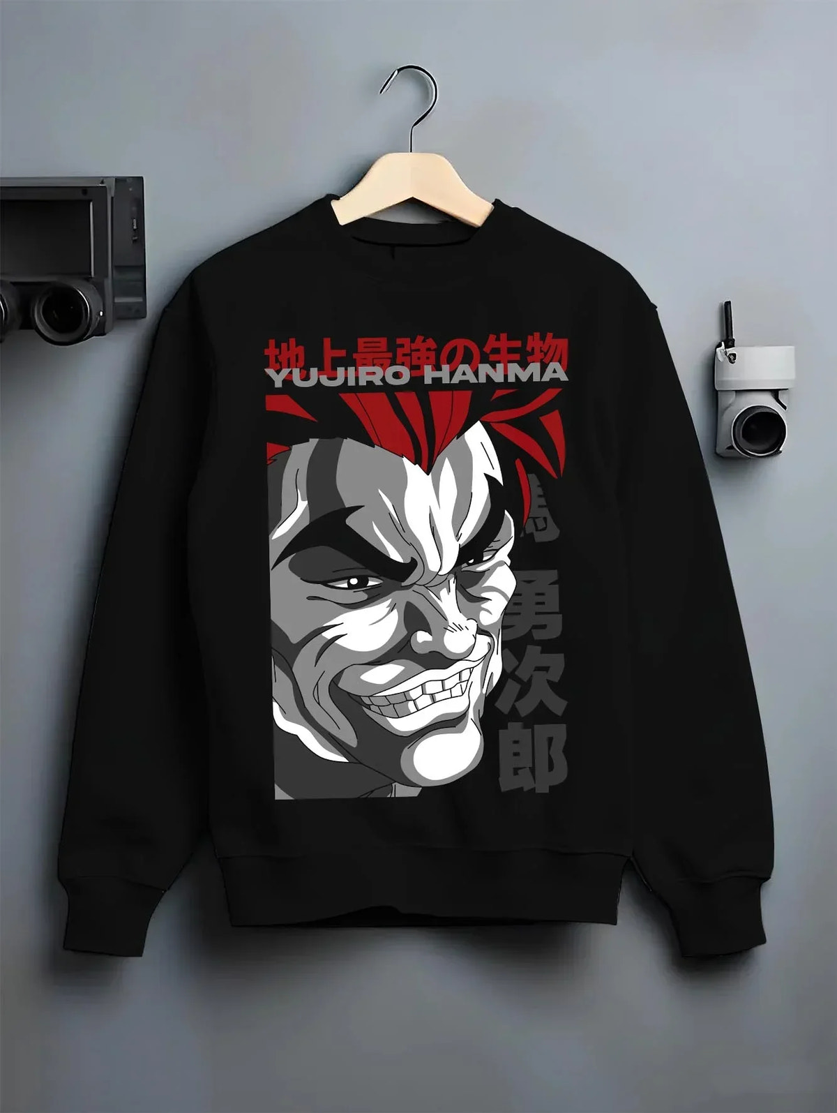 Black crewneck sweatshirt on hanger with Yujiro Hanma Hoodie Baki the Grappler Fierce Grin graphic premium wear.