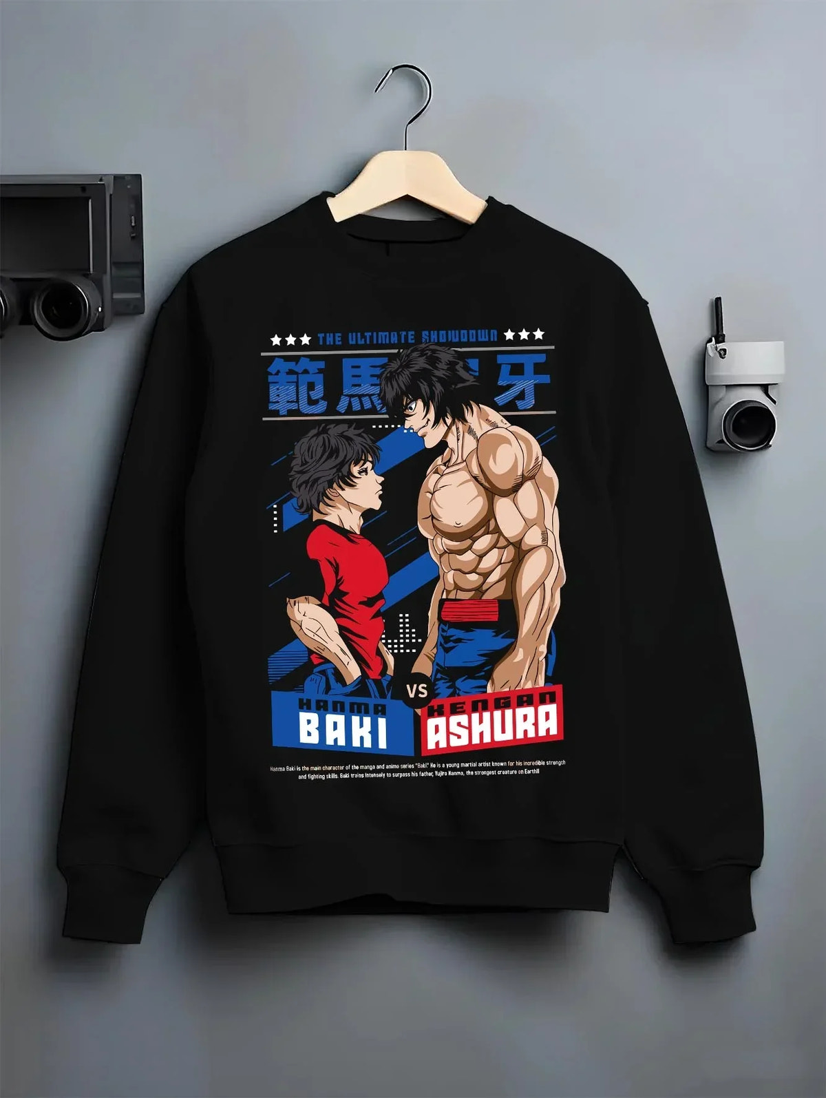 Black crewneck sweatshirt on hanger with Baki Fighters Hoodie Baki vs Kengan Ashura Battle Pose graphic bold anime graphic.