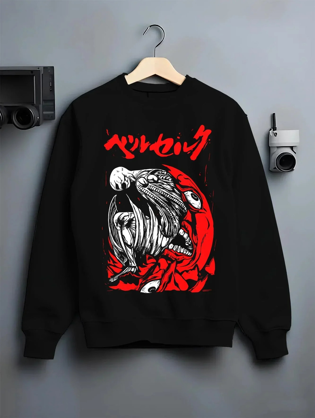 Black crewneck sweatshirt on hanger with Berserk Skull Hoodie Behelit Eclipse Bloody Crimson graphic streetwear graphic.