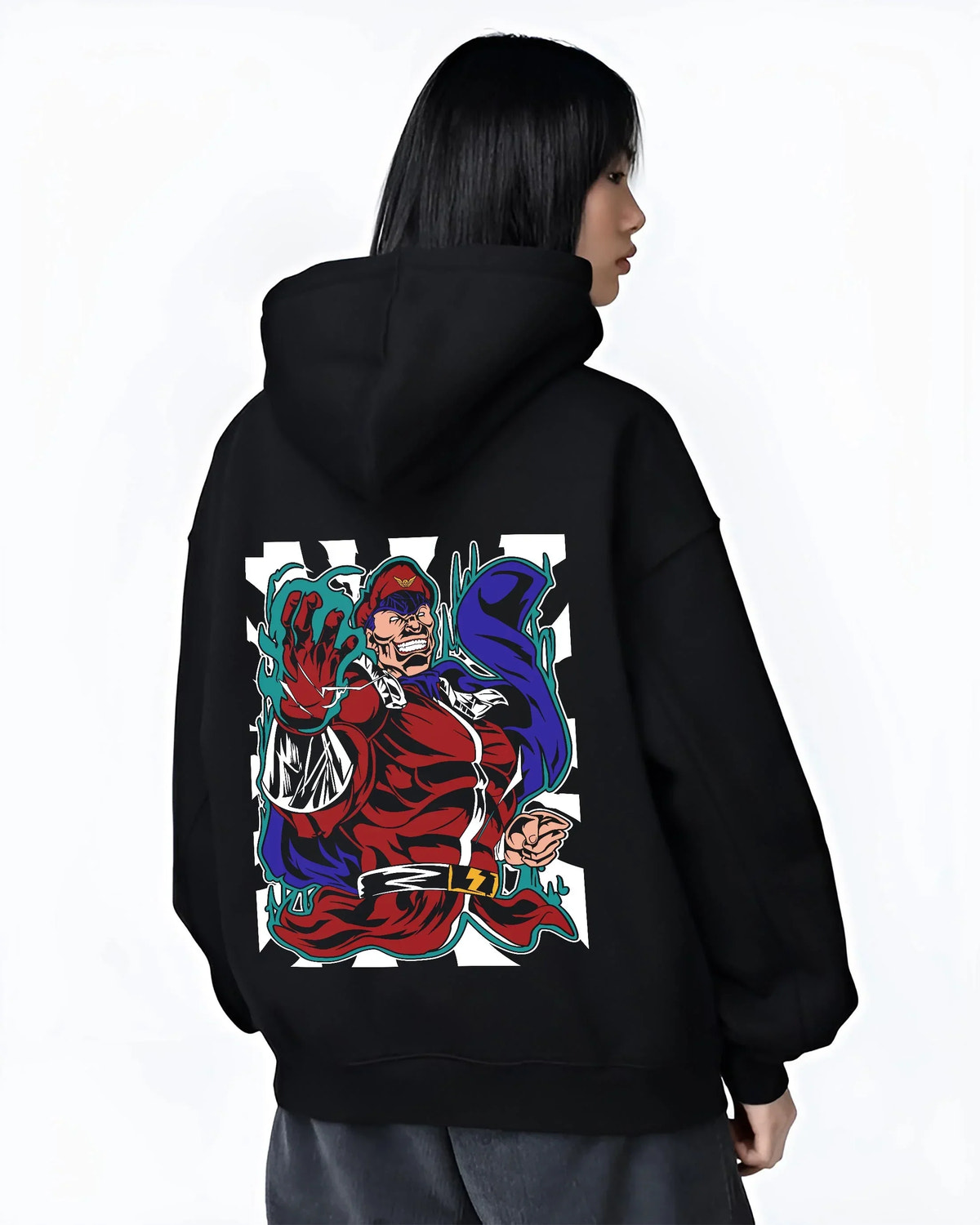 Black hoodie worn by female model, back view with M. Bison Hoodie Street Fighter Psycho Power Pose graphic premium wear.