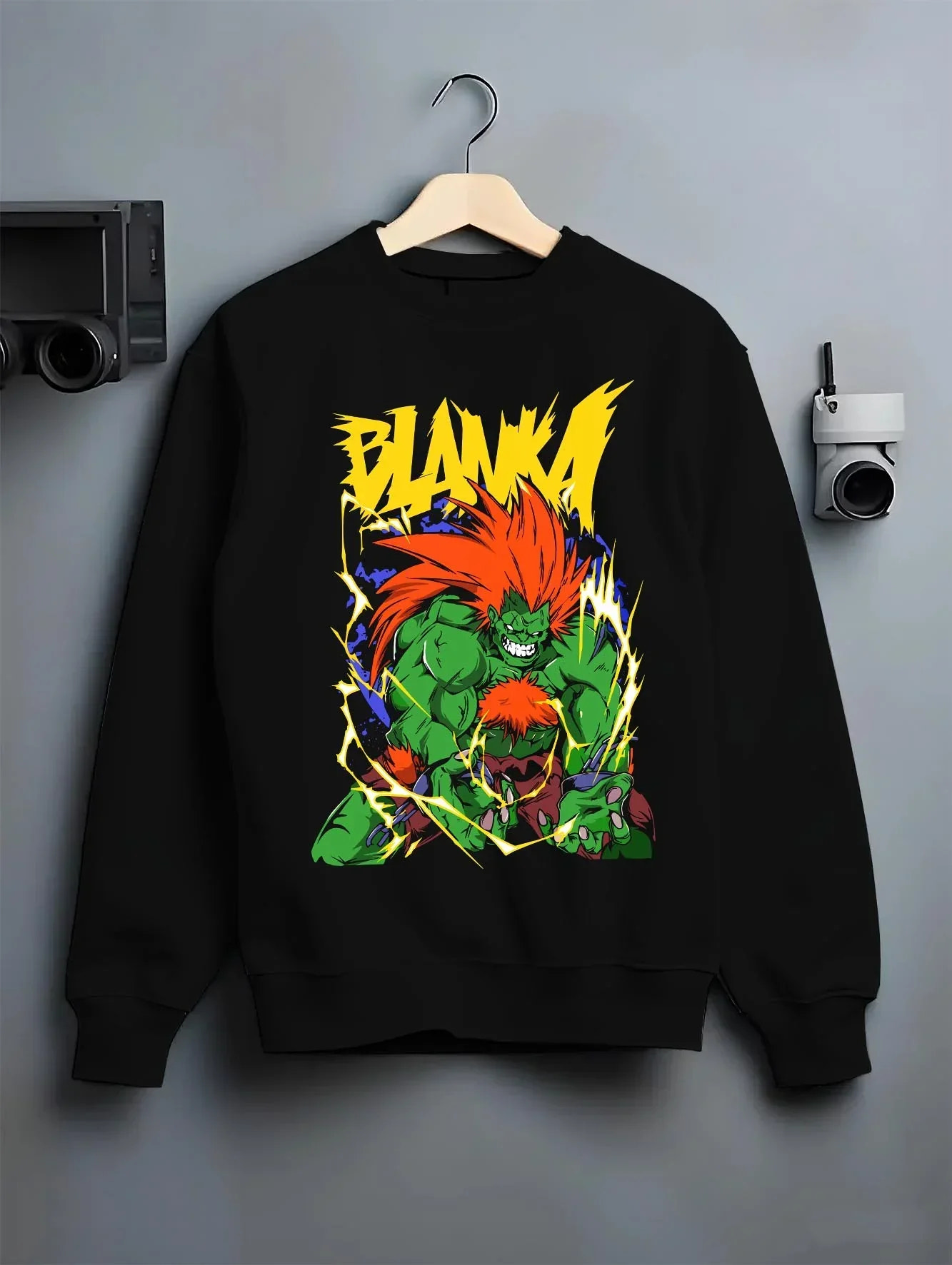 Black crewneck sweatshirt on hanger with Blanka Hoodie Street Fighter Green Beast Retro Roar graphic bold anime graphic.