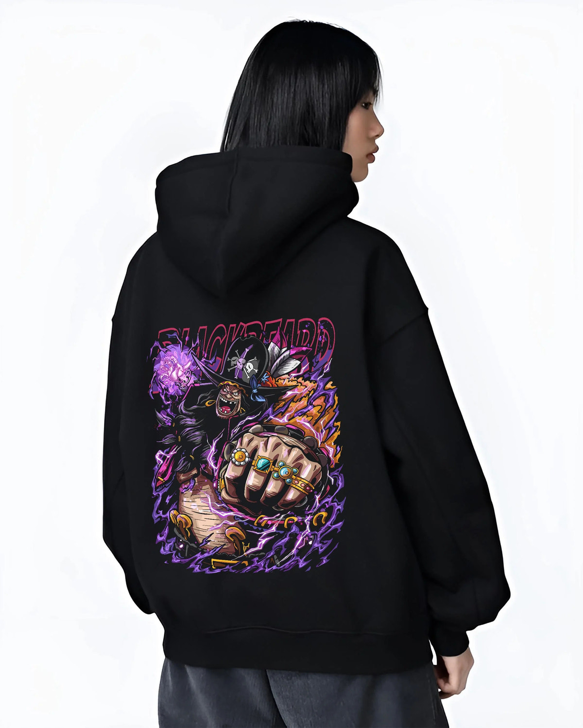 Black hoodie worn by female model from the back featuring Blackbeard One Piece dark power artwork.