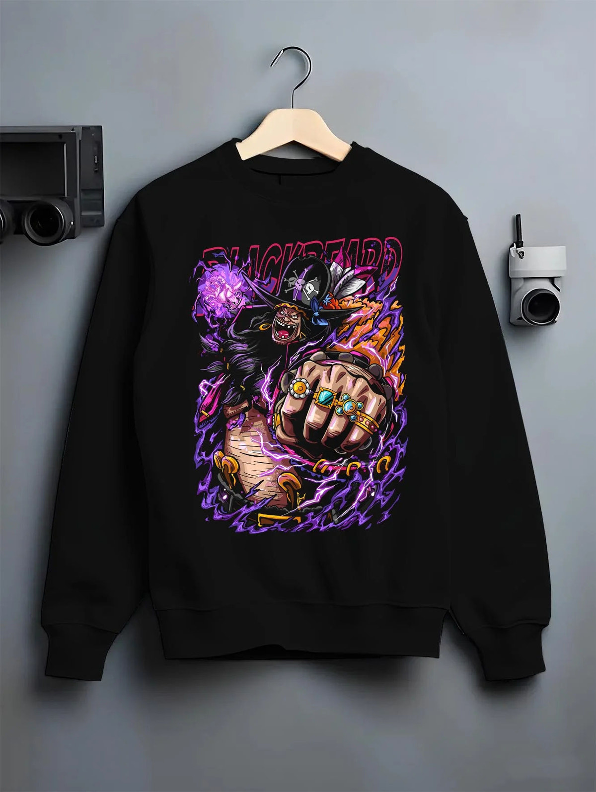 Black crewneck sweatshirt on hanger featuring Blackbeard One Piece dark power artwork.