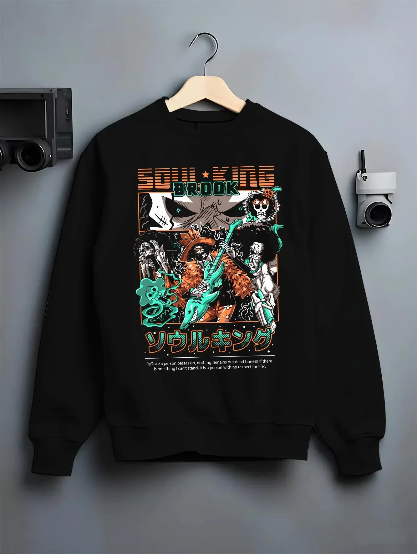 Black crewneck sweatshirt on hanger with Brook Soul King Hoodie One Piece Flame Music Scene graphic streetwear graphic.