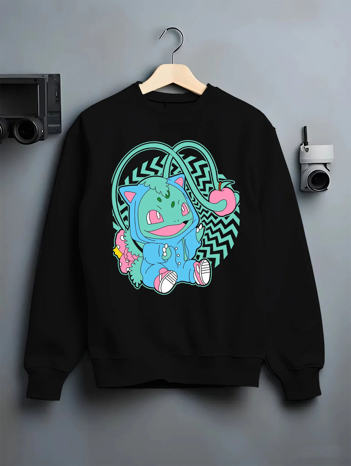 Black crewneck sweatshirt on hanger showing Bulbasaur from Pokémon: cute stylised illustration