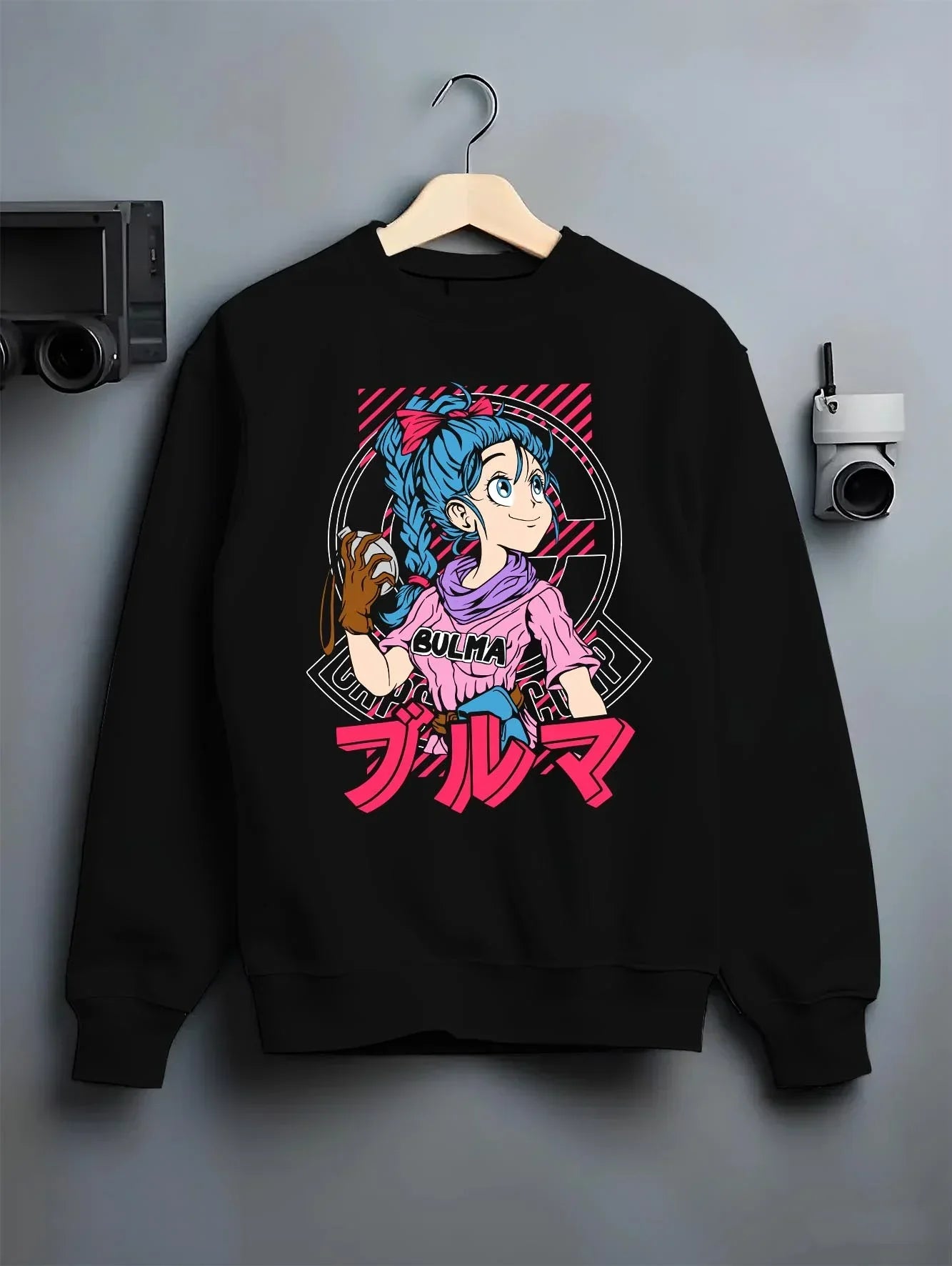 Black crewneck sweatshirt on hanger with Bulma Hoodie Dragon Ball Z Pink Outfit Capsule Corp graphic streetwear graphic.