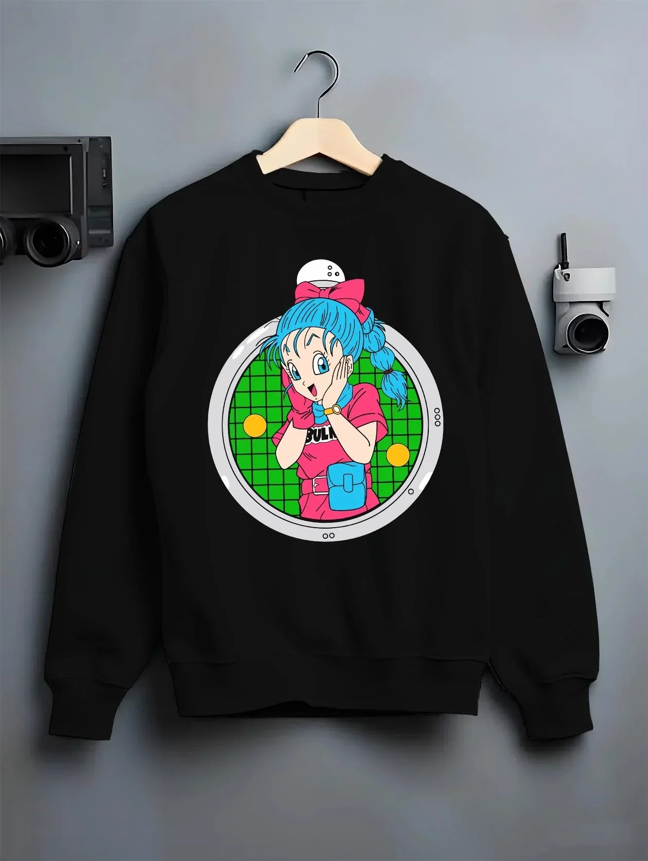 Black crewneck sweatshirt on hanger with Bulma Capsule Corp Hoodie Dragon Ball Z Retro Anime graphic streetwear graphic.