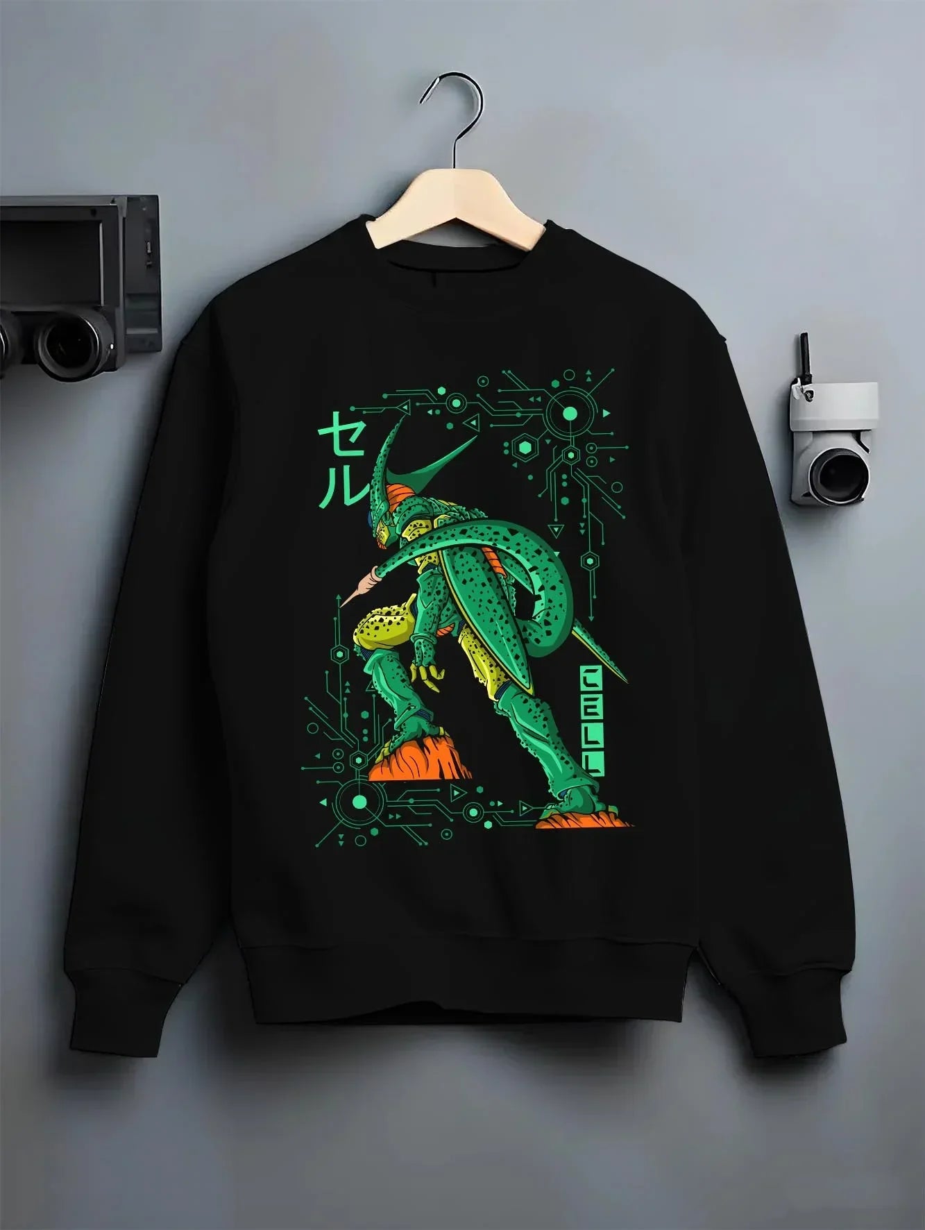 Black crewneck sweatshirt on hanger with Cell Hoodie Dragon Ball Z Perfect Villain Evolution graphic premium wear.