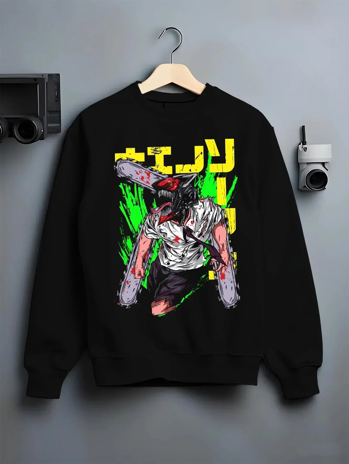 Black crewneck sweatshirt on hanger with Chainsaw Man Hoodie Denji Devil Hunter Green Slash graphic streetwear graphic.