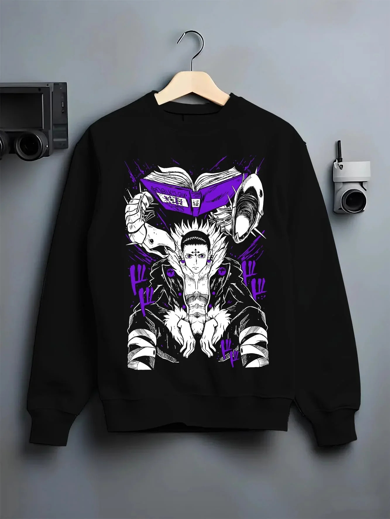 Black crewneck sweatshirt on hanger with Chrollo Hoodie Hunter x Hunter Phantom Troupe Leader graphic bold anime graphic.