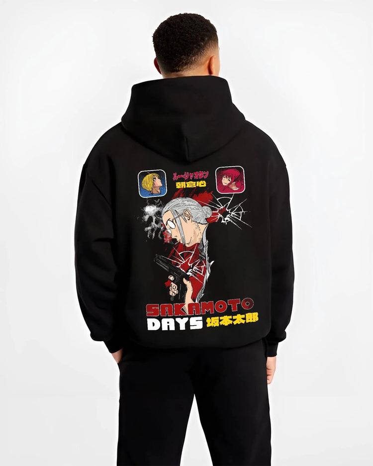 Black hoodie worn by male model from the back featuring Sakamoto Days combat manga artwork.