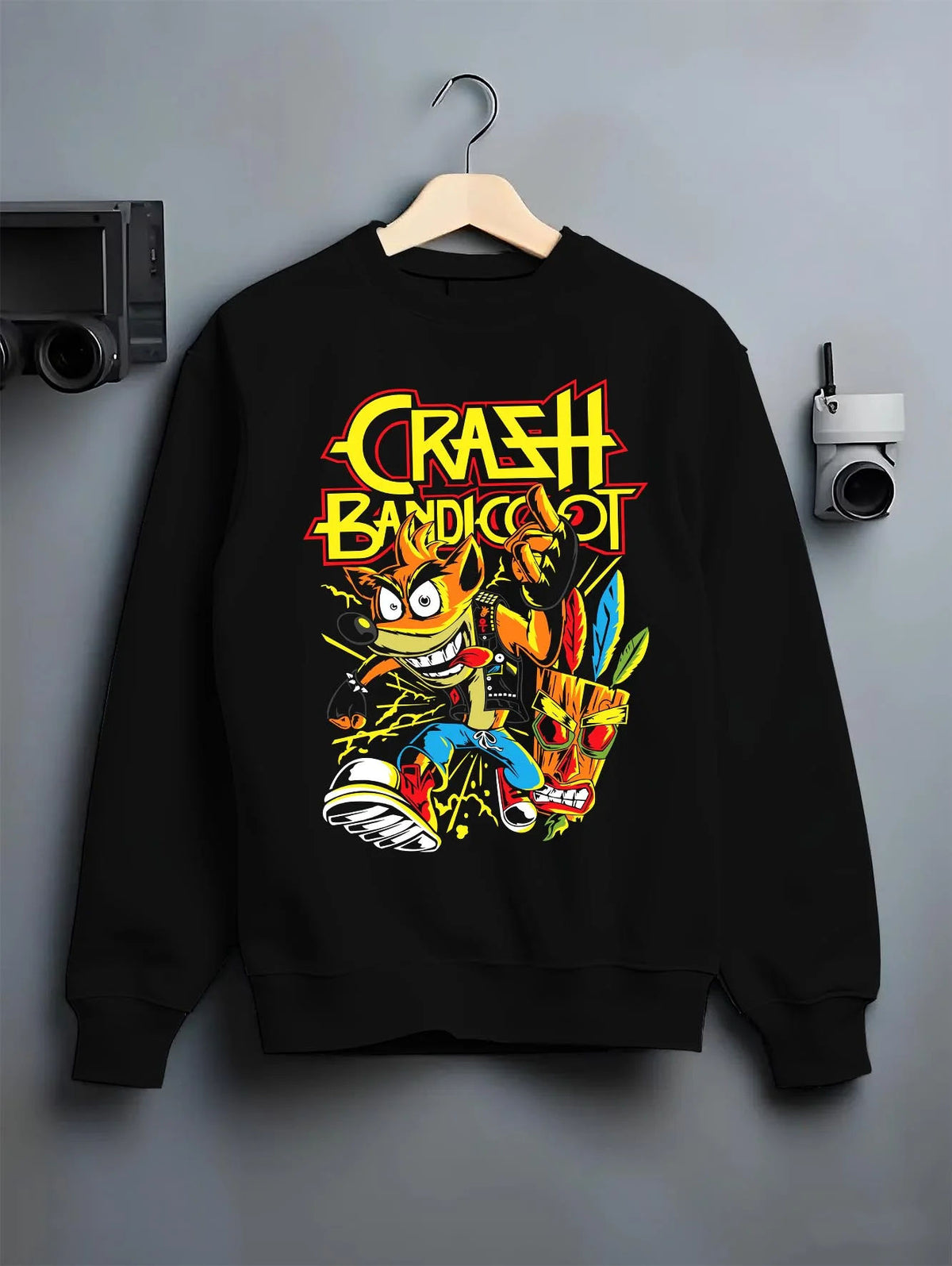 Black crewneck sweatshirt on hanger featuring Crash Bandicoot retro gaming spin action artwork.