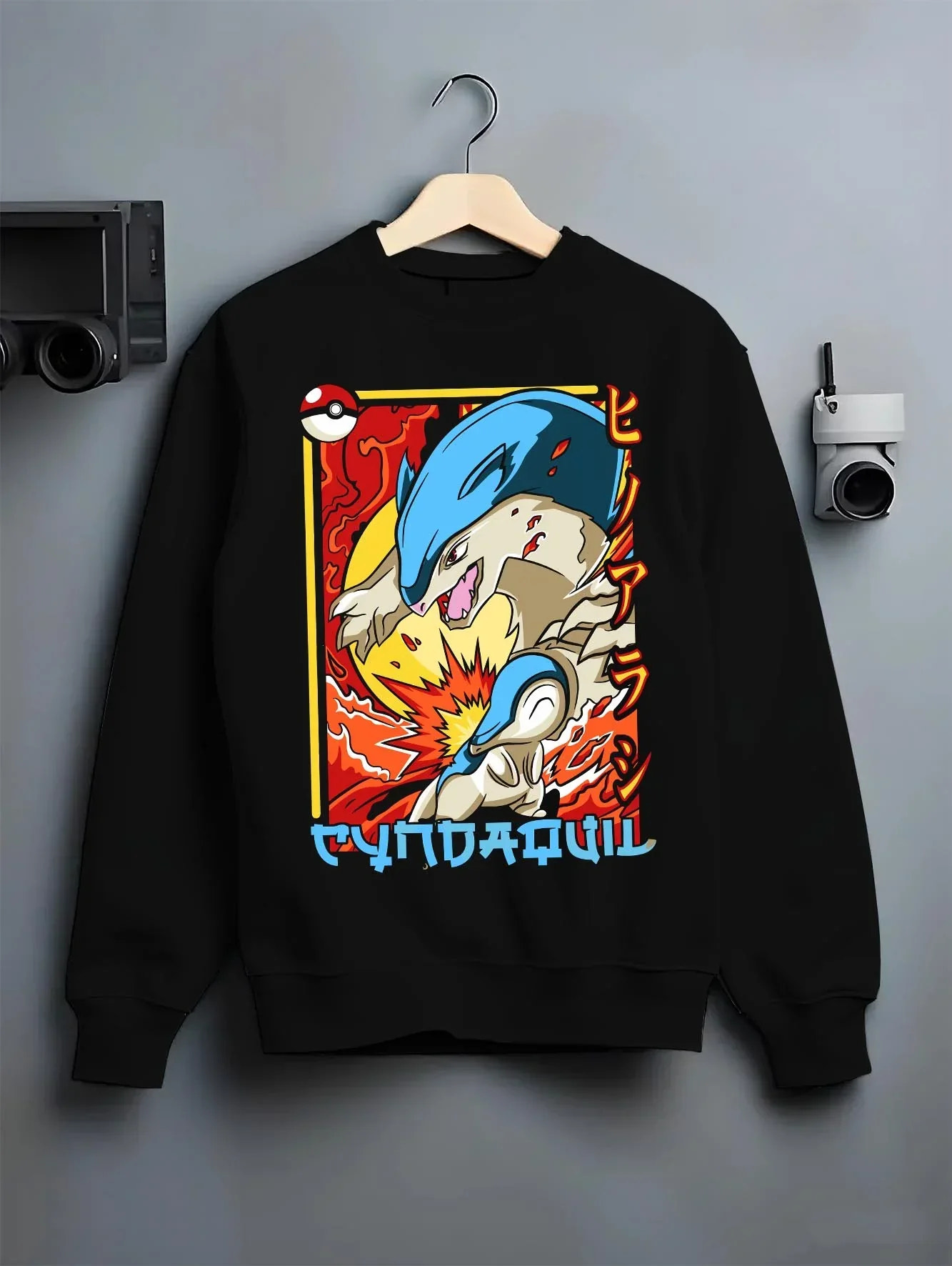 Black crewneck sweatshirt on hanger with Cyndaquil Hoodie Pokémon Retro Fire Starter Flame graphic bold anime graphic.