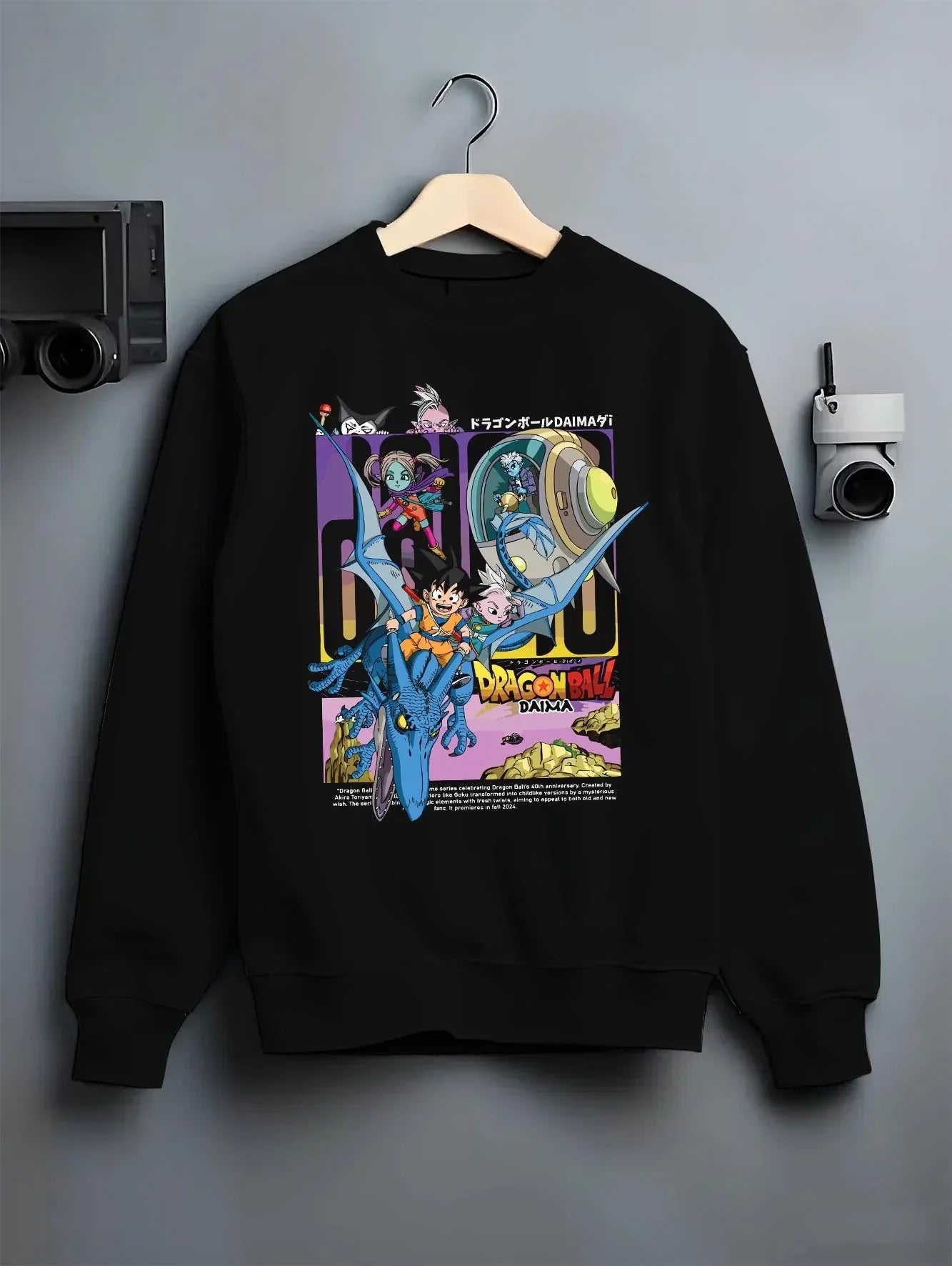 Black crewneck sweatshirt on hanger with Dragon Ball Hoodie Daima Anime Retro Poster Scene graphic Goku anime design.