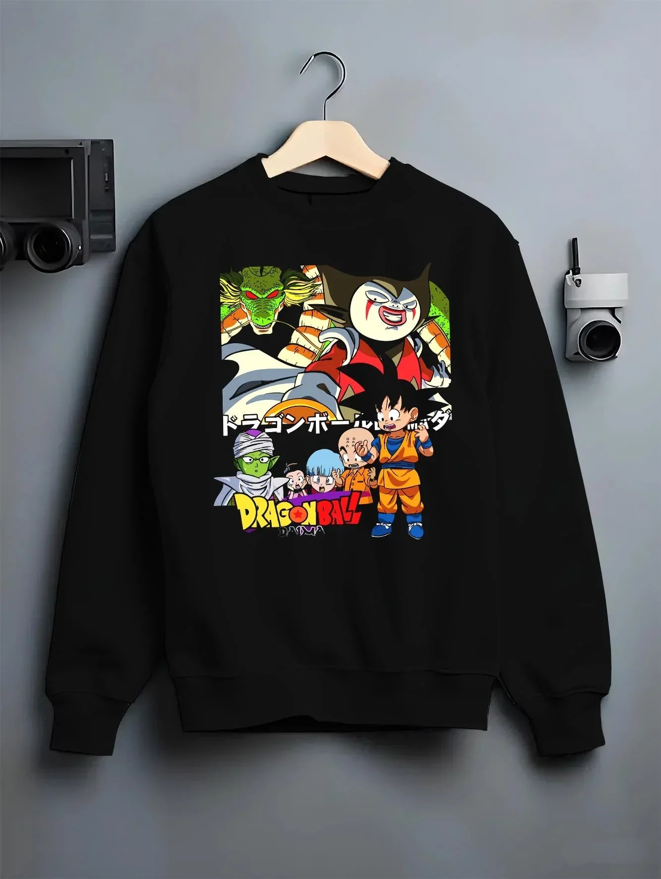 Black crewneck sweatshirt on hanger with Dragon Ball Daima Hoodie New World Anime Heroes graphic bold anime graphic.