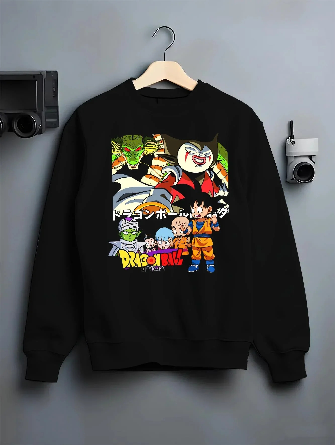 Black crewneck sweatshirt on hanger with Dragon Ball Daima Hoodie New World Anime Heroes graphic bold anime graphic.