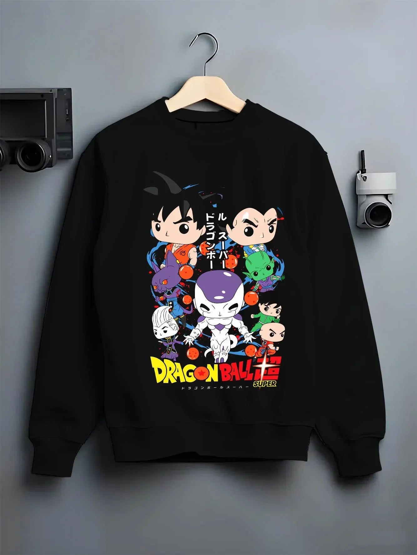 Black crewneck sweatshirt on hanger with Dragon Ball Hoodie Villains Retro Anime Poster Art graphic streetwear graphic.