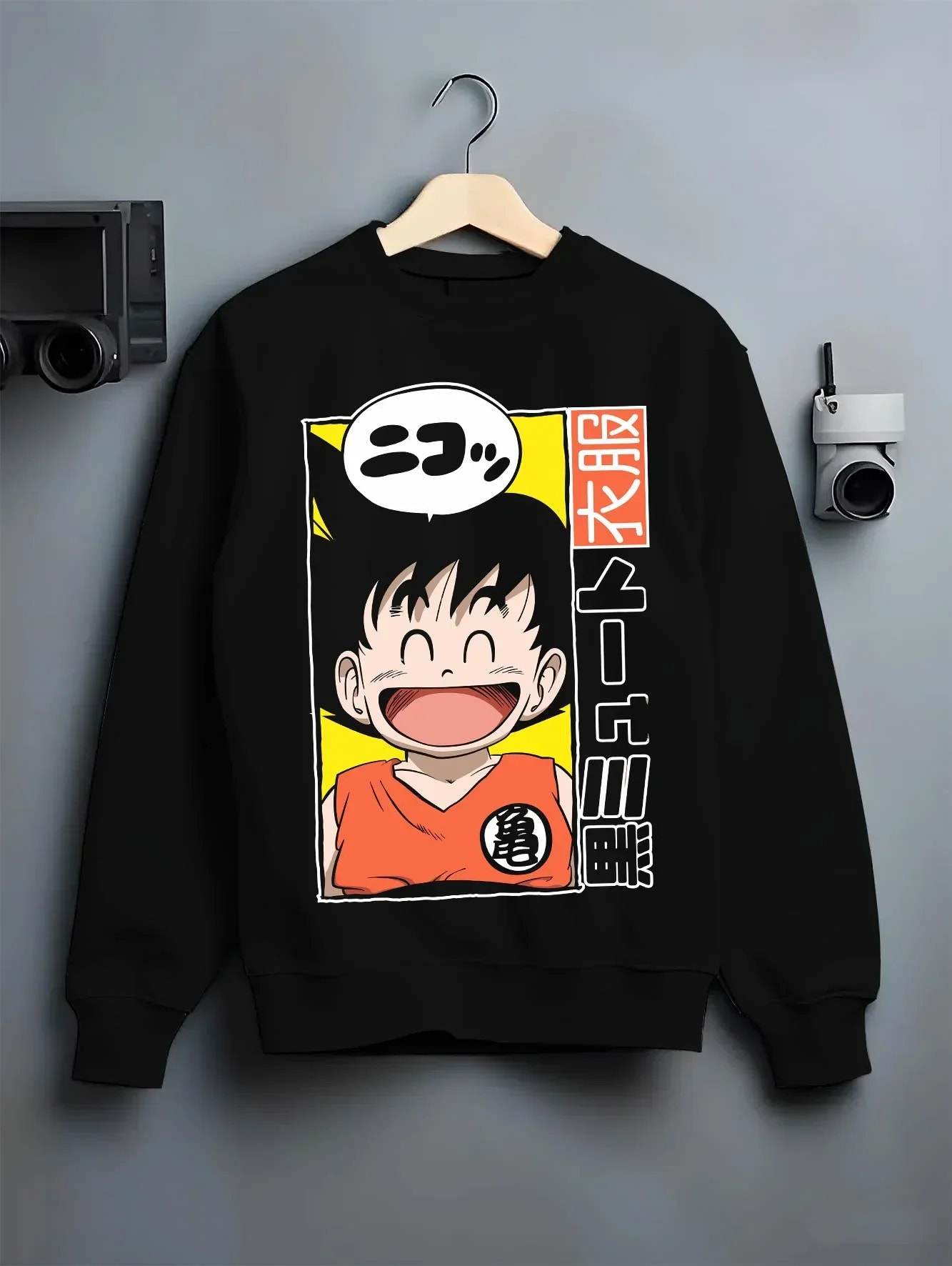 Black crewneck sweatshirt on hanger with Krillin Hoodie Dragon Ball Retro Nimbus Flying Pose graphic streetwear graphic.