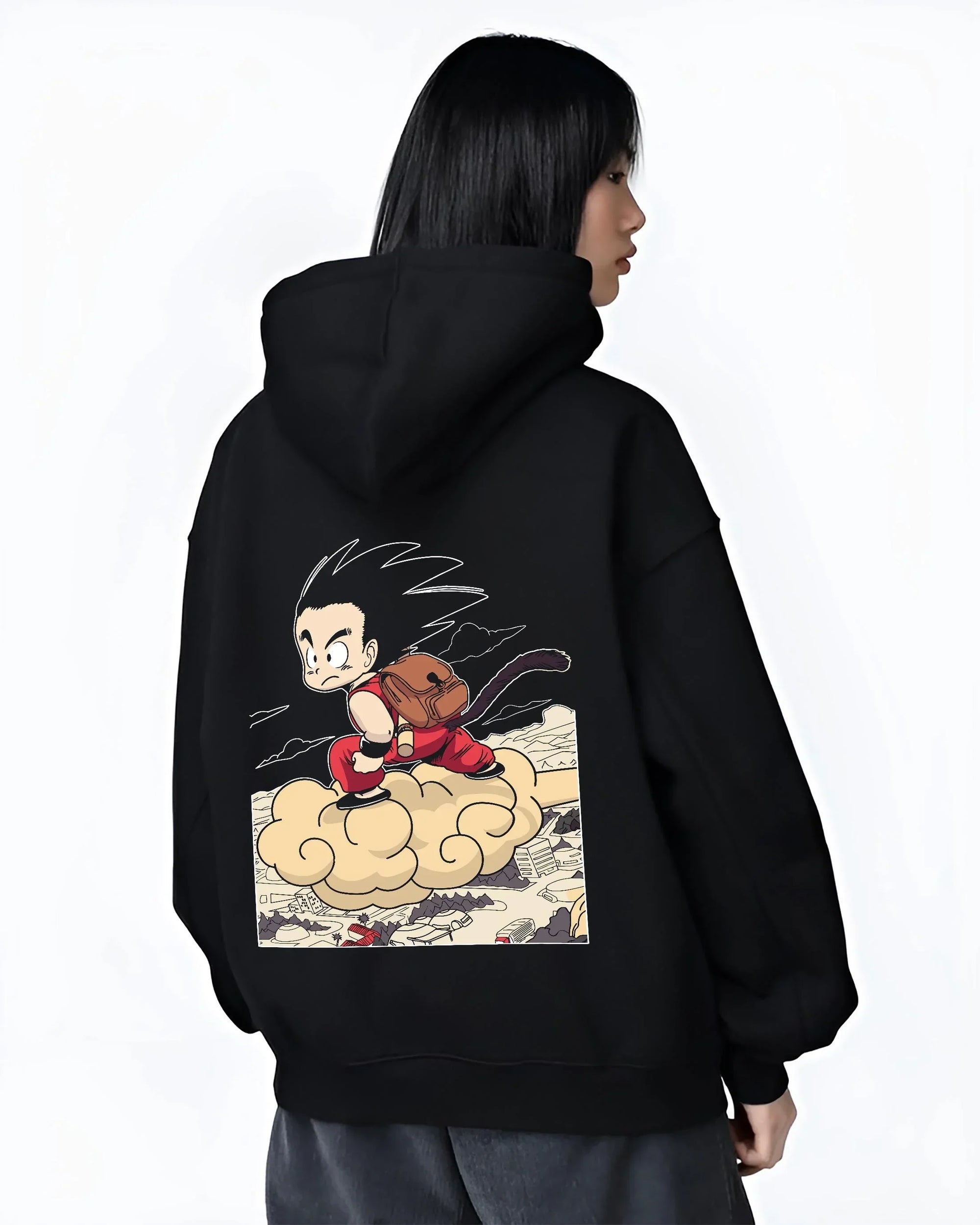 Black hoodie worn by female model, back view with Goku Hoodie Dragon Ball Kid Nimbus Cloud Adventure graphic streetwear graphic.