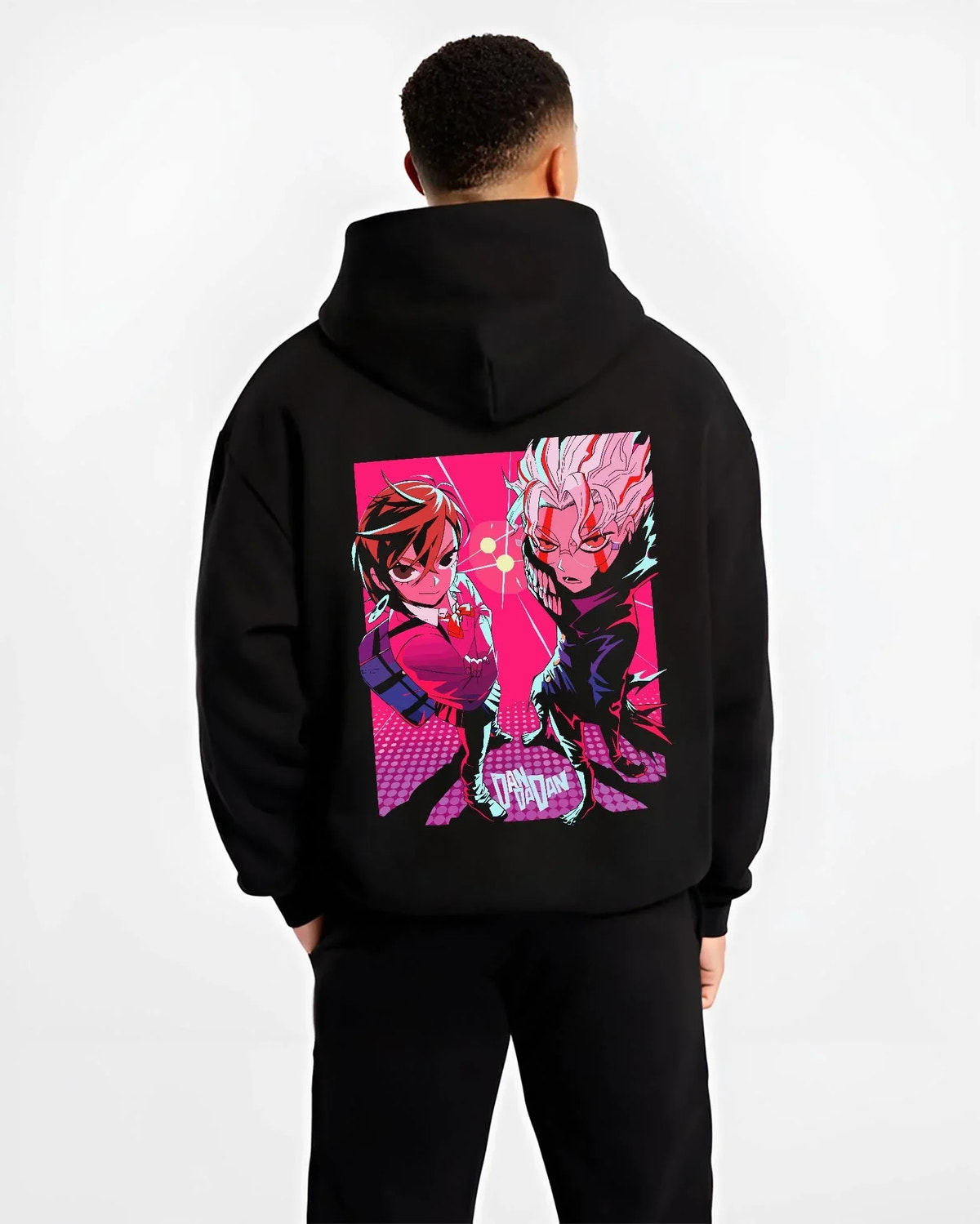 Black hoodie worn by male model, back view with Dandadan Duo Hoodie Paranormal Adventure Retro Anime graphic bold anime graphic.