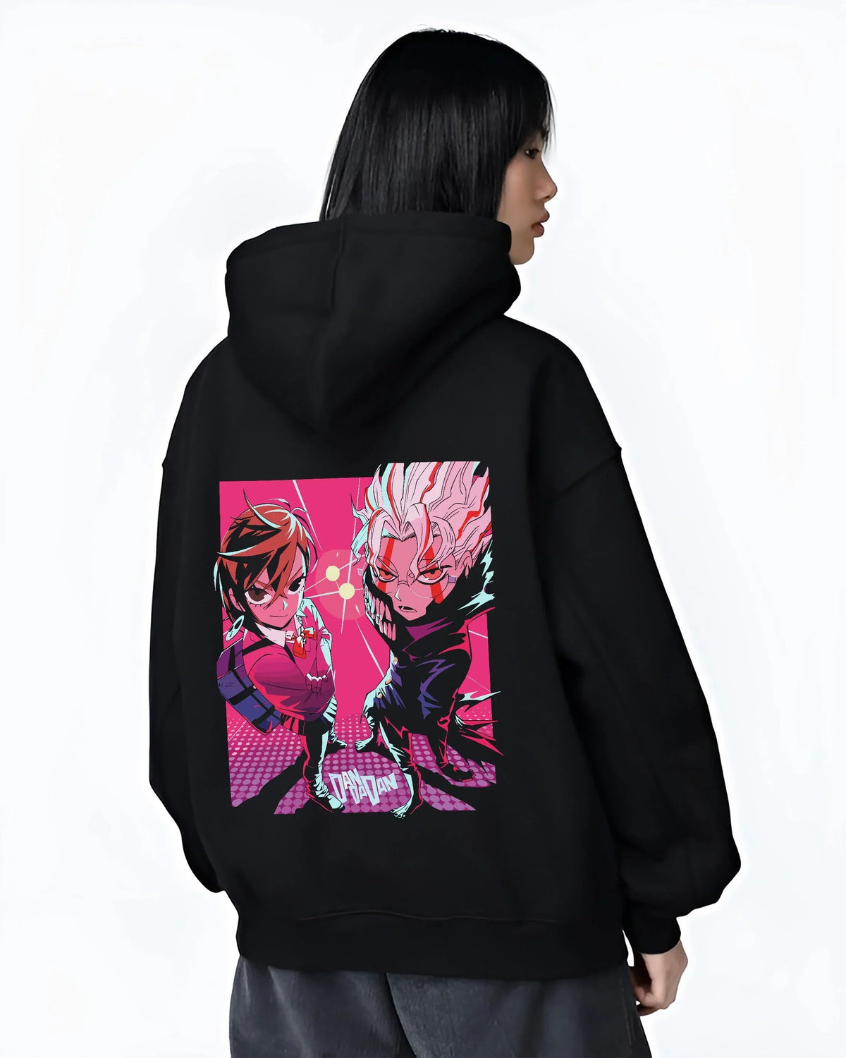 Black hoodie worn by female model, back view with Dandadan Duo Hoodie Paranormal Adventure Retro Anime graphic bold anime graphic.