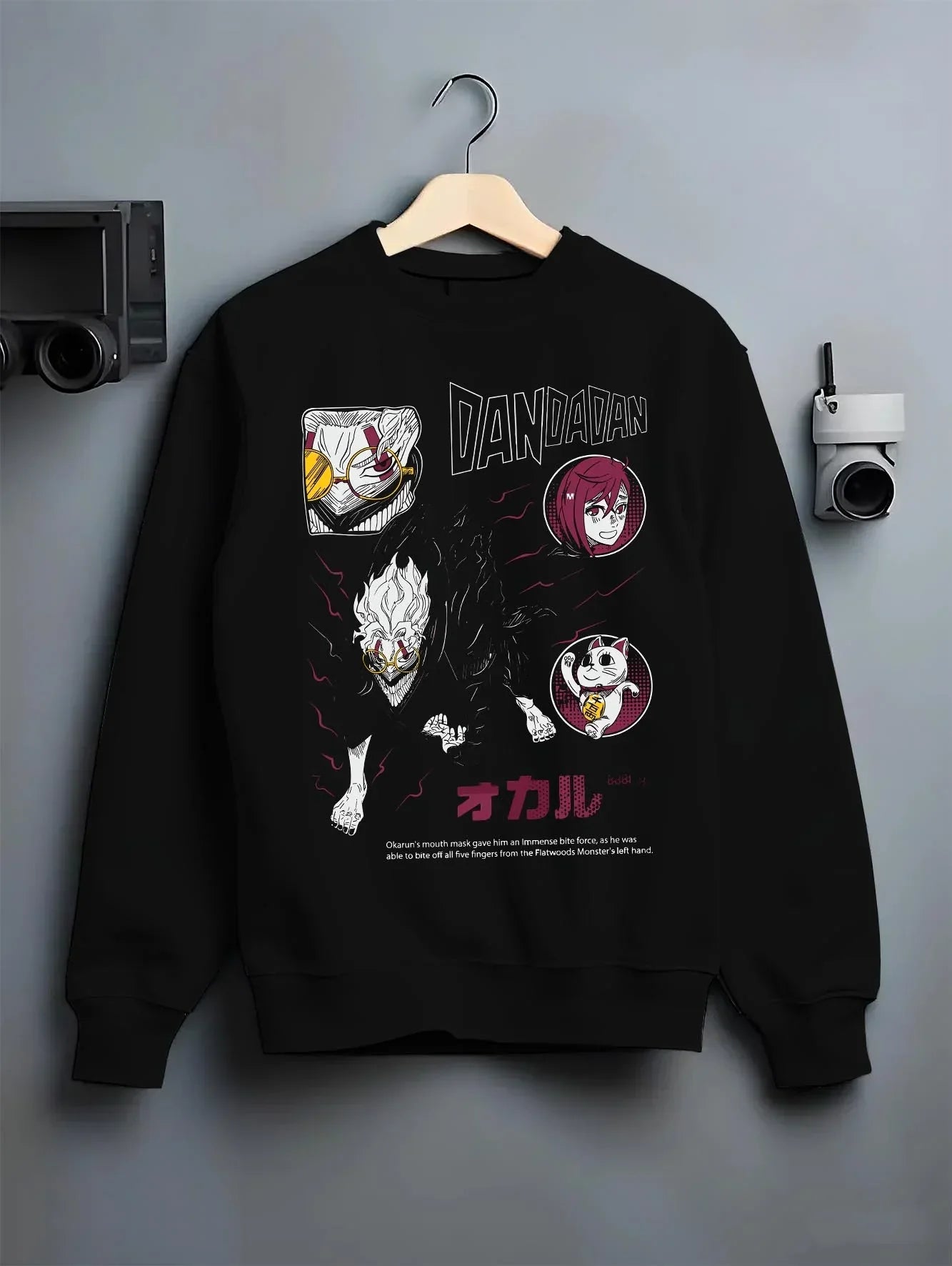Black crewneck sweatshirt on hanger with Dandadan Hoodie Paranormal Battle Horror Retro Print graphic bold anime graphic.