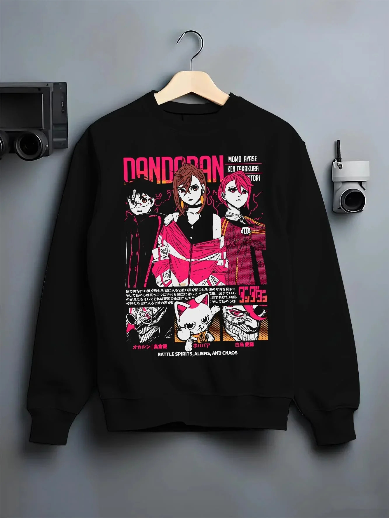 Black crewneck sweatshirt on hanger with Dandadan Hoodie Paranormal Duo Retro Anime Poster graphic premium wear.